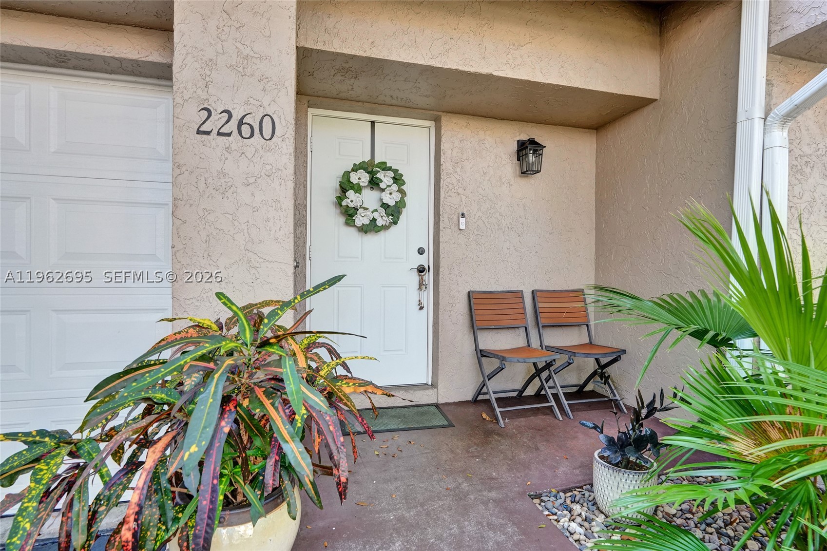 Beautifully updated 2-bedroom, 2.5-bath townhouse situated on a large lot with mature trees, just steps from the pool, tennis and pickleball courts, and clubhouse in the highly sought-after Discovery Pointe community. Quiet interior location in the community. Gated community with night-time security. Dog friendly community. 

This lovely home features a desirable split floor plan and numerous upgrades, including a new A/C unit, impact garage door, upgraded attic insulation for improved energy efficiency, new light fixtures and faucets, new screening on back porch, a stylish barn door in the primary bedroom, redesigned kitchen with a new stove, new ceiling fans, and new carpet on the stairs. Additional updates include a new roof, new gutters, and a new water heater.

The home offers a spacious living room and a formal dining area. The kitchen showcases beautiful off-white cabinetry, generous countertop space, a stylish tile backsplash, and stainless-steel appliances.

The spacious primary bedroom features an updated en-suite bathroom and a walk-in closet with custom cabinetry. The second bedroom is also en-suite with a large closet.

Enjoy year-round outdoor living on the large, tiled, screened-in patio overlooking a beautiful lake view.