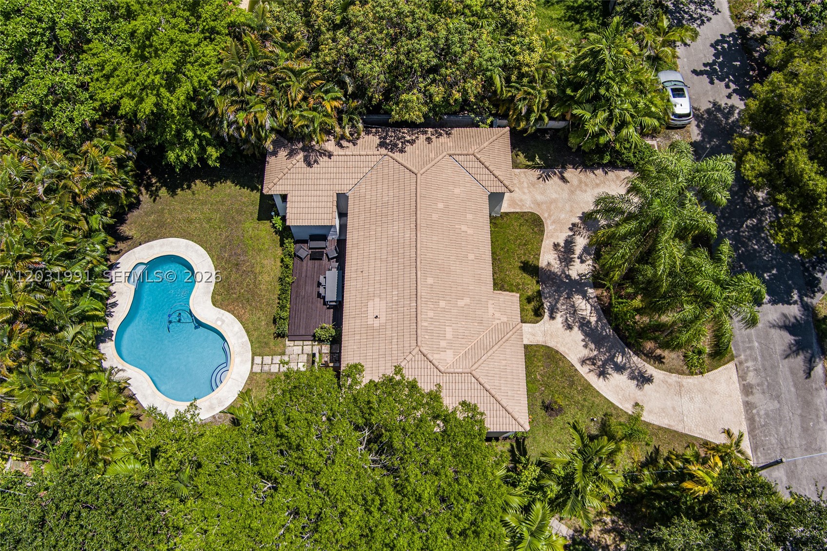 Tucked away on a quiet cul-de-sac in the heart of Miami Shores, this beautifully maintained 3-bedroom, 2-bath residence blends timeless charm with effortless indoor-outdoor living. Sunlight pours through impact windows and doors, highlighting gleaming wood floors and clean, modern design throughout. The bright kitchen opens directly to the pool terrace through expansive glass doors, creating the perfect setting for entertaining or everyday enjoyment. Outside, a private walled backyard feels like a secluded retreat, with mature tropical landscaping framing the sparkling pool. A circular driveway, one-car garage, tankless water heater (2019), and updated A/C system (2020) add convenience and peace of mind. Just moments from Miami Shores' beloved Village Place, you'll enjoy easy access to local cafés, restaurants, boutiques, and community events that define the neighborhood's unique small-town appeal. Combining privacy, style, and a sought-after cul-de-sac location, this special home offers the best of Miami Shores living.