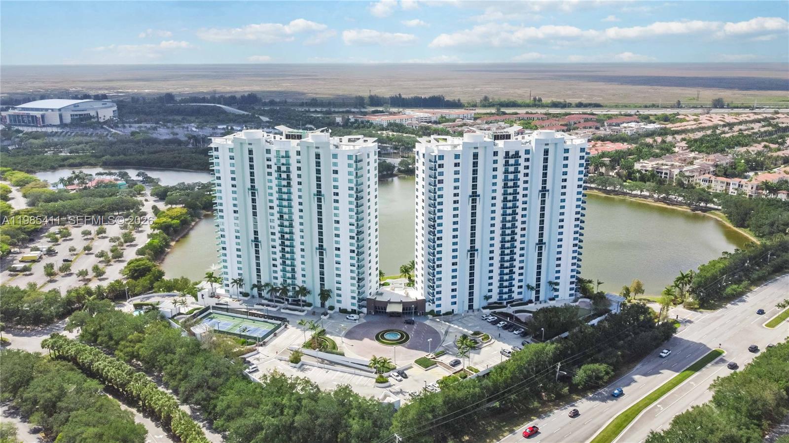 Enjoy easy living in this bright and spacious 1-bedroom, 1.5-bath condo at Tao at Sawgrass. The unit features beautiful laminated floors, a modern kitchen with granite countertops, and stainless steel appliances. Relax on your private balcony with peaceful lake views and stunning sunsets. The building offers great amenities like a resort-style pool, fitness center, and clubhouse. Perfectly located just a short walk to Sawgrass Mills Mall for shopping and dining, with quick access to the Sawgrass Expressway and Flamingo Road.