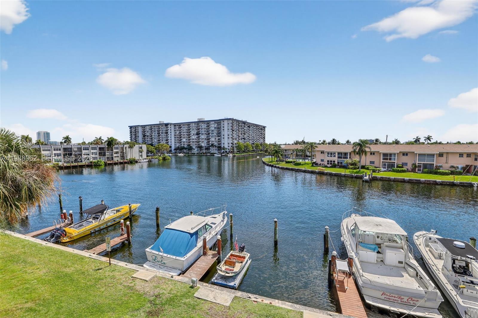 BOATER'S DREAM with deeded dock! Rarely available, this south-facing 2BR/2.5BA residence in the exclusive gated enclave of Nobel Point showcases a newer roof and new A/C, refrigerator, water heater, dishwasher, and washer/dryer. Bathed in natural light, this striking waterfront townhome captures mesmerizing views from two oversized, roofed and screened balconies on both levels, defining an elevated coastal lifestyle. The refined interior offers a generous open layout with marble flooring on the main level and thoughtfully updated kitchen and baths. Upstairs, two spacious bedrooms feature en-suite baths, with the primary suite showcasing sweeping waterfront views that create a true vacation-at-home experience. Your deeded dock includes water and electric and accommodates up to a 42’ vessel with swift Intracoastal and ocean access. Residents enjoy resort-style amenities including tennis, pickleball, heated pool and spa, clubhouse, fitness center, tropical outdoor grilling oasis, and car wash. Pet-friendly, allowing up to two pets. Includes parking for two vehicles (one covered, one uncovered). Ideally located approximately 2.5 miles to the beach and moments from premier shopping, dining, and major roadways. This prized south-facing wide-water dock orientation enhances maneuverability for larger vessels and adds enduring value. A true Boating Enthusiast’s Paradise, privately tucked within the beautiful Garden Isles community with ocean access via only one fixed bridge.