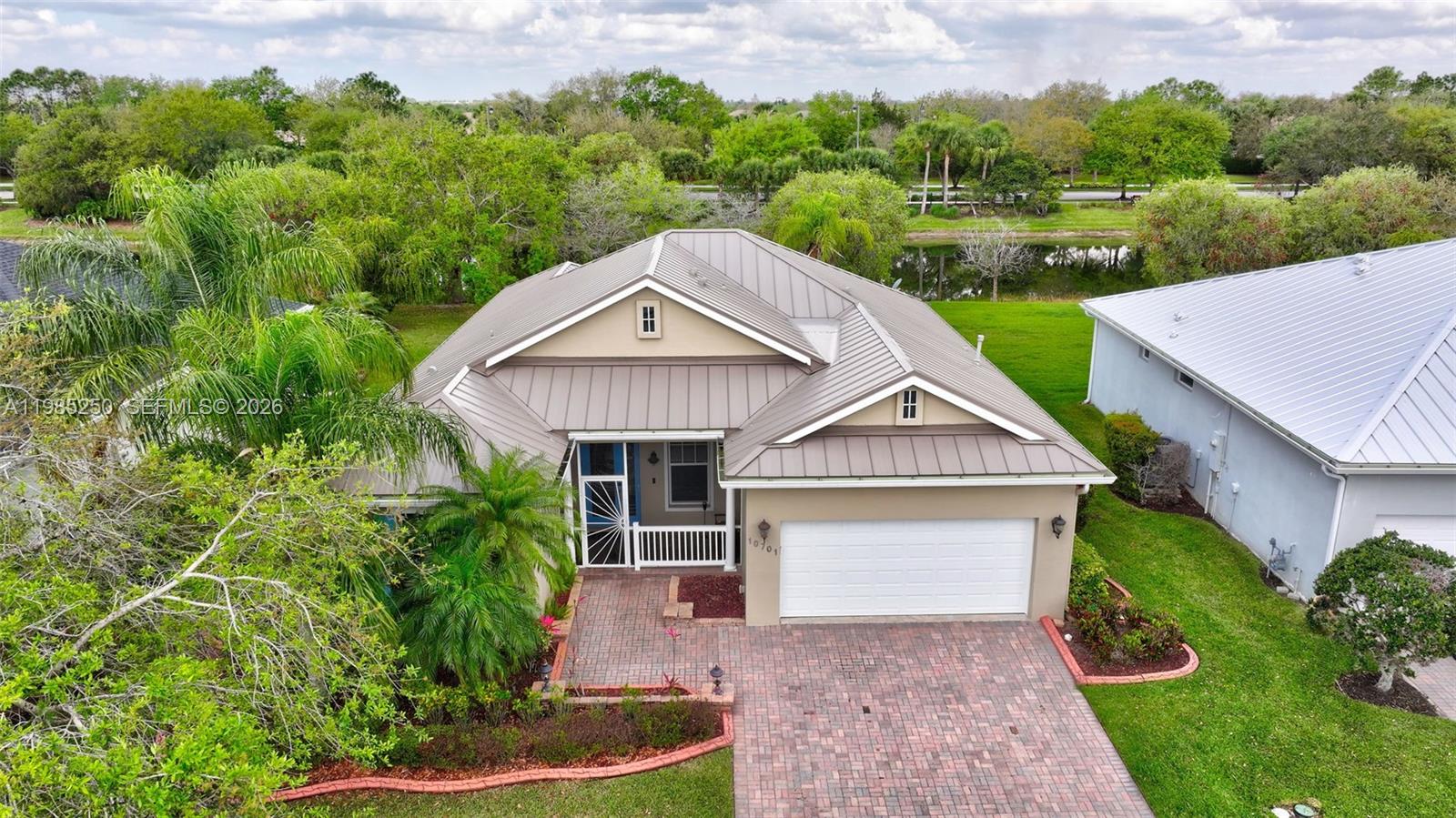 Welcome Home! To your single family turn key paradise located within Waterfront Bedford park home in tradition. This CBS home has an open floor plan with split 3 bedrooms and 2 bathrooms, updated granite kitchen and updated full tiled bathrooms. In the last 4 years new metal roof, gutters, trane AC, tankless hot water and accordion shutters. This home has a covered front porch and a back screened patio with an extensive water view to relax and enjoy. The HOA includes a large community pool, lawn care with landscaping, cable, tv, alarm system, internet, and a landline for local calls. Close to tradition square near shopping and dinning. Conveniently located to I-95 and A+ Schools.