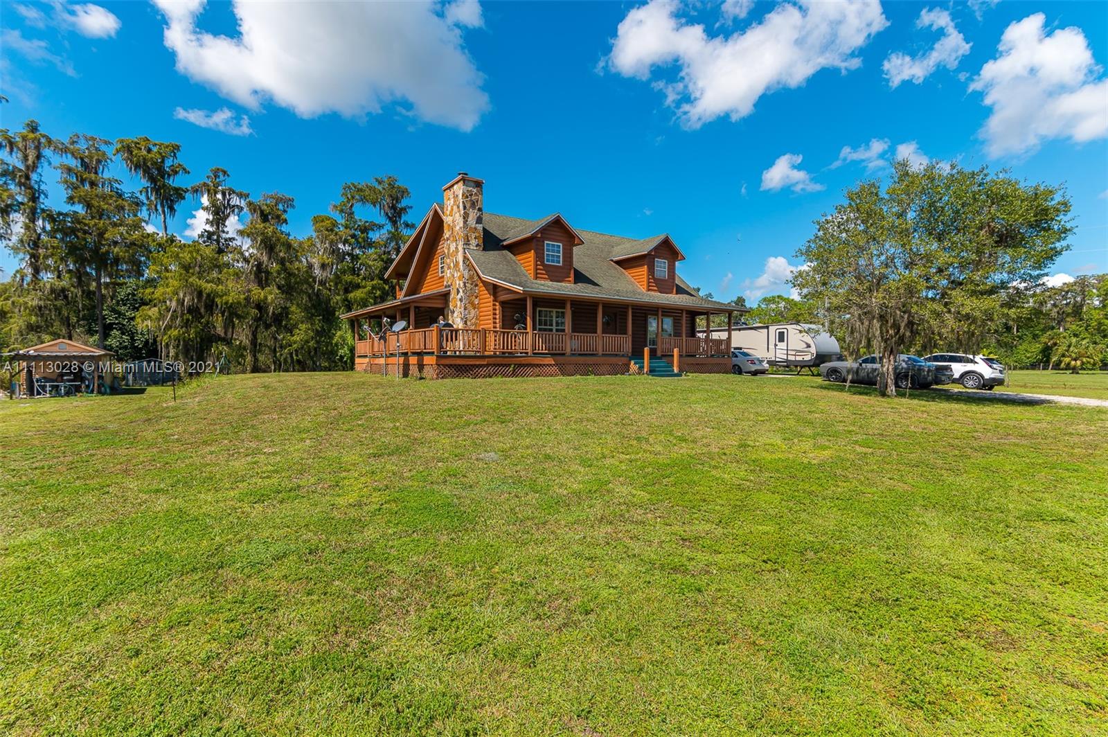 THIS IS A MUST SEE VERY UNIQUE LOG CABIN HOME CUSTOM BUILT WTH TIDEWATER RED CYPRESS LOCATED IN MONTURA RANCH ESTATES HOME OFFERS A WRAP AROUND PORCH ON 2.5 ACRES PROPERTY HAS 3 BEDROOMS 2 BATHROOMS MASTER IS LOCATED DOWN STAIRS UPSTAIRS YOU WILL FIND A LOFT WITH 2 BEDROOMS AND JACK AND JILL BATH BOTH ROOMS HAVE ACCESS TO HUGE PORCH THIS HOME IS ONE OF A KIND WITH A LARGE FIREPLACE "METAL RV CARPORT NOT INCLUDED IN SALE PRICE" CALL ME FOR MORE INFORMATION.