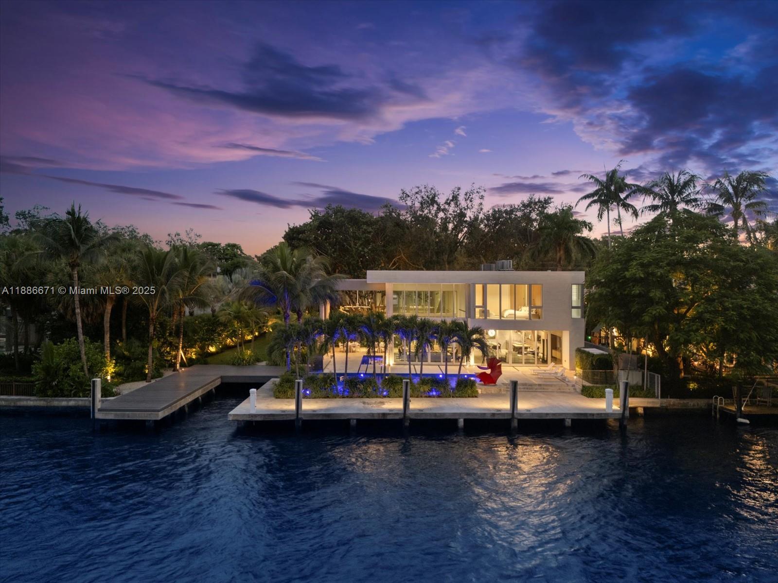 Set on prestigious Rio Vista Boulevard, this modern estate blends sophistication and exclusivity, offering 122 ft of prime New River frontage plus a dedicated cutout for a 38-ft vessel. 6,823 SF of interiors showcase cinematic downtown & Intracoastal views, soaring ceilings, and glass walls flooding the home with natural light. The primary suite is a private retreat with a spa-quality bath & boutique-style closets - one of four en-suites including a second primary. A designer kitchen connects to formal & casual living areas opening to the water. Outdoors, a resort pool, summer kitchen, manicured gardens, & impeccable landscaping create an elegant setting. Private elevator, home office, & collector’s two-car garage complete this exceptional residence near Las Olas and Lauderdale Yacht Club.