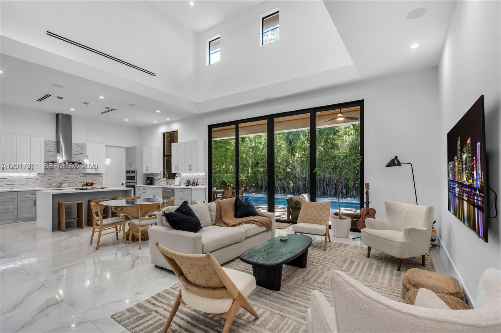 Sophisticated, modern 2019 built Coral Gables residence offering privacy, clean architectural lines, and seamless indoor/outdoor living. Positioned on a lush 10,500 SF corner lot, this 4BD/4.5 BA home across 2,834 adjusted SF features volume ceilings, large impact windows and doors, large-format porcelain floors, and bright open living spaces filled with natural light. Spacious kitchen with center island flows effortlessly into the expansive main living area and covered terrace. Resort-style backyard with pool and mature landscaping creates a private retreat ideal for entertaining. Flexible bedroom with private entrance perfect for guests, home office, or gym. 2-car garage with lift capability plus additional driveway parking. Prime central Coral Gables location near Miracle Mile, top schools, restaurants, and shopping.