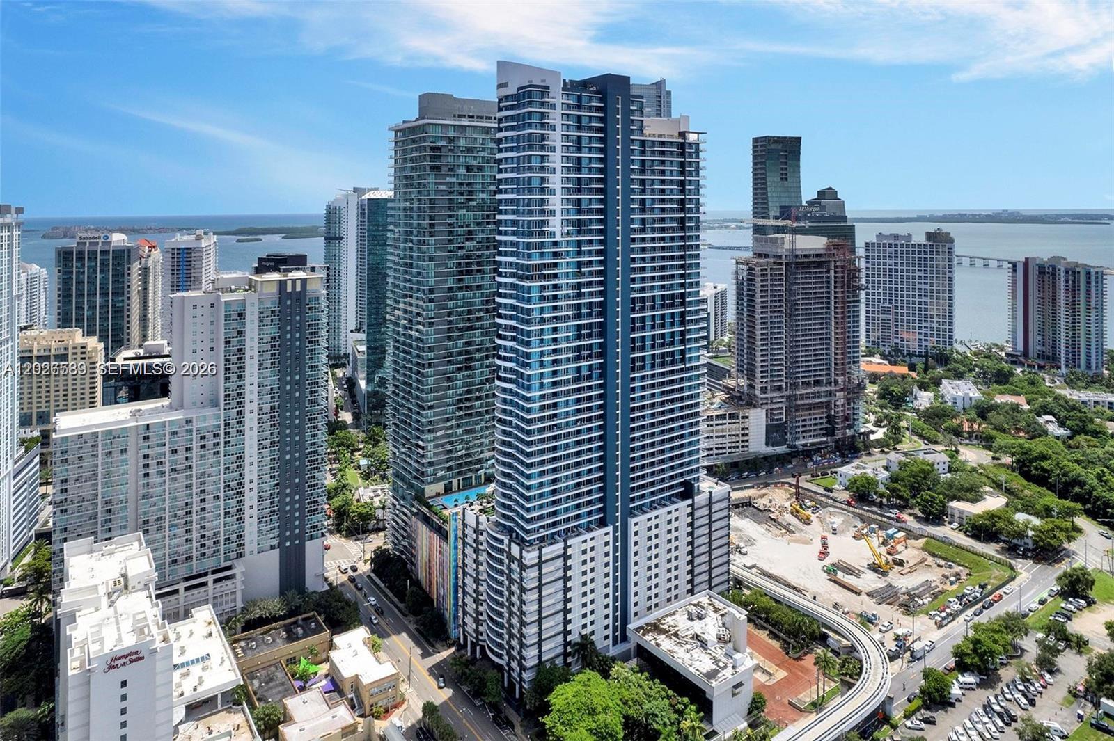 Rare 1-of-1 two-story sky-loft at Infinity at Brickell — a beautiful, fully renovated residence with incredible views. The staircase was relocated to open up the floor plan and expand the second-floor footprint, creating flow and volume no other unit in the building offers. Soaring double-height glass frames stunning city views, with an oversized first-floor balcony and a private second-floor balcony off the primary suite. Tastefully updated throughout for elevated living and effortless entertaining.
Building amenities include a state-of-the-art fitness center, pool, sauna, steam room, cold plunge, rooftop jacuzzi, and BBQ deck/common area, plus a 24-hour attended lobby. A lobby market serves breakfast and lunch and stocks the last-minute essentials you need for your home, and on-site car wash service is available right in the garage.
Located in the heart of Brickell and within walking distance to Publix — steps from Brickell City Centre, Mary Brickell Village, premier dining, nightlife, and the financial district. A truly one-of-a-kind opportunity in one of Miami's most coveted addresses.