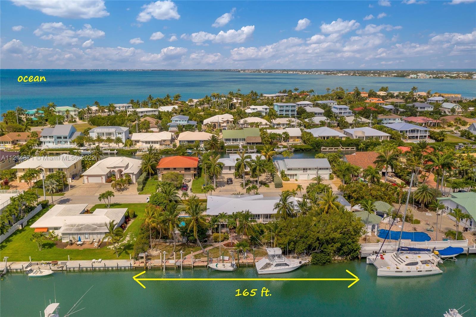 Private, east-facing oasis boasting 165 ft. of water frontage on an over-sized palm tree lined lot! Concrete dock equip w/ water, electric & its own lobster colony ideal for the boating enthusiast housing a 15,000lb. lift. 6ft. deep canal nearly 100 ft wide w/ instant Vaca Cut access to pursue the Ocean or Bay.  Sizable swimming pool surrounded by lush landscaping for private relaxation. Over 3,300 sq. ft. of living space to enjoy inside this two-story home starting with its 1st floor apartment.  The main floor living is centered around the beautiful water views and has a spacious floor plan, granite kitchen which will (new stainless steel appliances coming soon) 2 car garage, double paver driveways, new metal roof (2020), additional storage w/ the A/C'd garden shed + Tesla charger.