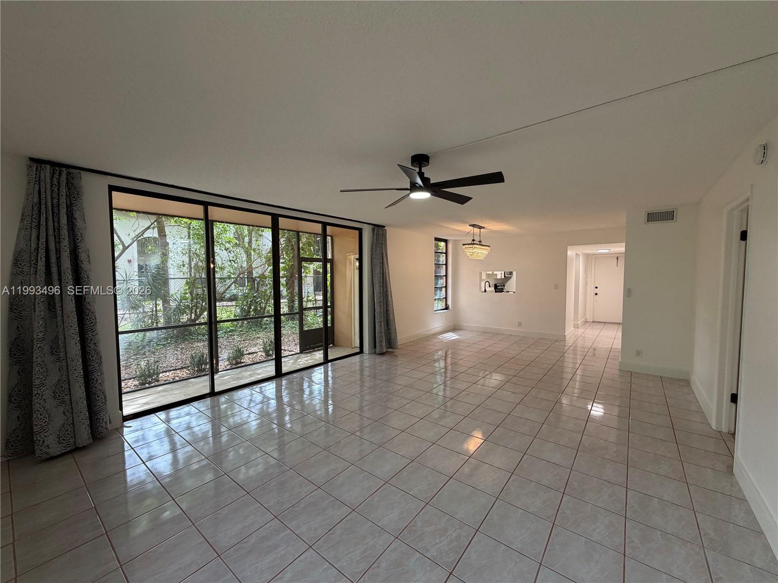 Don’t miss this opportunity to own a spacious and well-positioned 2 bedroom, 2 bathroom corner unit in the highly desirable Lago West community in Plantation. Situated on the first floor, this residence offers an expansive 1,130 square foot layout with a bright open living and dining area, split bedroom floor plan, and a large screened-in patio overlooking peaceful canal and garden views. The corner positioning provides added privacy and an abundance of natural light throughout. Recently updated for comfort and modern living, the unit features a clean interior with tile flooring throughout, an updated kitchen with ample cabinetry, and newly renovated bathrooms. The layout flows seamlessly, making it ideal for both everyday living and entertaining. Both bedrooms are generously sized with walk-in closets and easy access to full bathrooms. The property includes hurricane protection, covered parking conveniently located right in front of the unit, and is move-in ready, while still offering the opportunity to personalize and add value over time. Lago West is a well-maintained community offering a clubhouse, pool, fitness center, tennis courts, and beautifully maintained grounds. Ideally located just minutes from I-595 and I-75, Sawgrass Mills Mall, top-rated schools, dining, shopping, and Fort Lauderdale-Hollywood Airport, this property offers excellent convenience in a central Plantation location. A great opportunity for both end-users and investors alike. Vacant & easy to show.