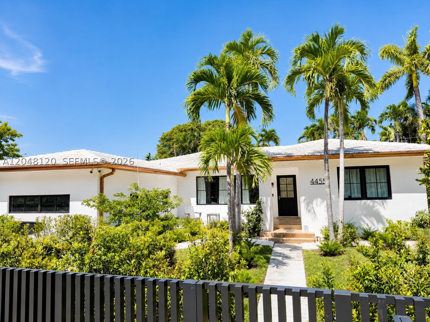 A rare opportunity on prestigious North Bay Road, one of Miami Beach’s most sought-after residential addresses. Set on a private, non-waterfront lot on North Bay Road, in coveted Mid-Beach, this light-filled single-story mid-century residence offers an open layout, flexible living spaces, and easy indoor-outdoor flow Inside, wide-plank white oak floors extend throughout the main living areas. The kitchen features a large quartz-topped island, white shaker-style cabinetry with brass hardware, and a striking blue AGA range. The adjoining great room and dedicated dining area are filled with natural light through hurricane-impact windows, while a media wall anchors the main living area.The floor plan includes a primary suite, two additional bedrooms, and a separate garden-facing office. A former garage was converted into a room with an en-suite bathroom prior to Seller’s acquisition of the Property. Available Miami-Dade County and City of Miami Beach building records do not show permits for the conversion or bathroom. Buyer should independently verify permit status, lawful use, code compliance, insurability, and any corrective requirements. New concrete tile roof (2019), hurricane-impact windows (2024), and the bronze aluminum gate and fence (2024). Zoned for highly rated North Beach Elementary School. Conveniently located near South Beach, houses of worship, Mount Sinai Medical Center, and Bal Harbour Shops. Square footage per Miami-Dade County Property Appraiser.