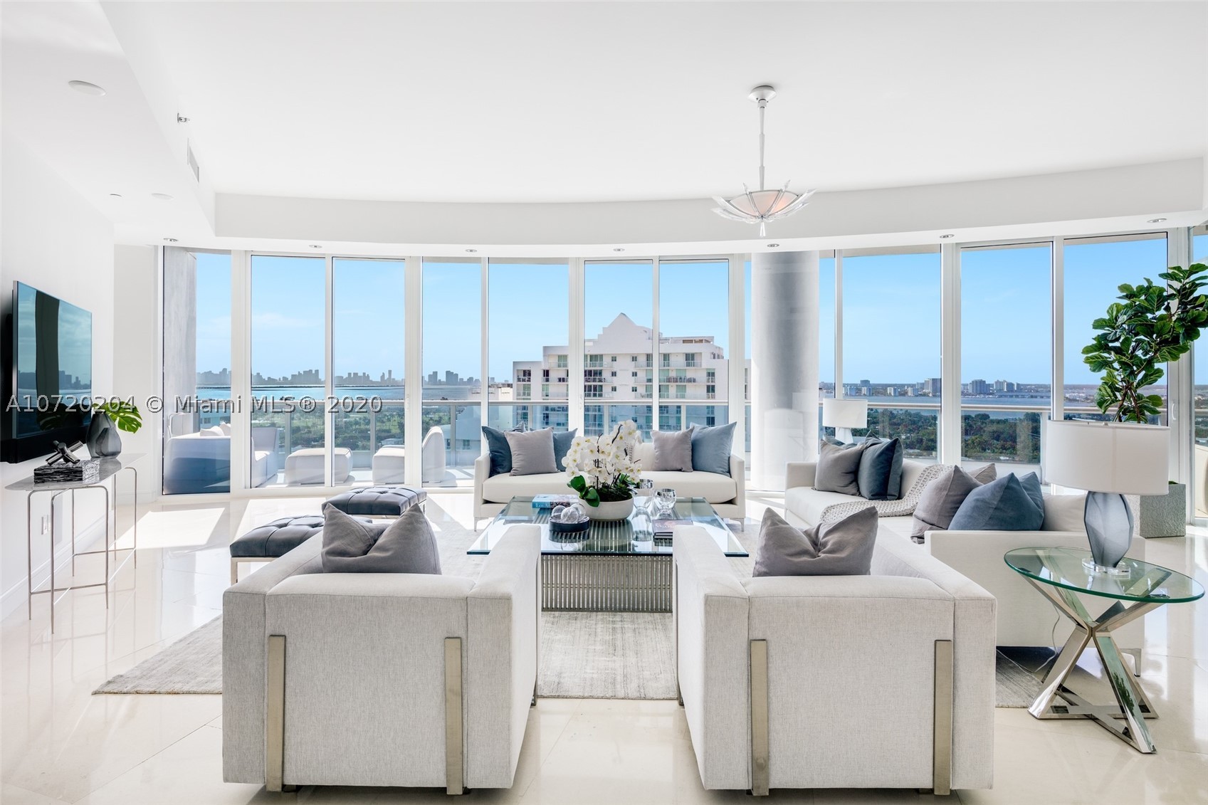This open floorplan house in the sky located on the PH level offers panoramic 120° wraparound views of the ocean, Miami skyline and Biscayne Bay at the prestigious Bath Club. This one-of-a-kind combined unit with elevator opening directly to the unit boasts floor-to-ceiling windows, 11’ ceilings, 2018 state-of-the-art Crestron controlled audio & visual/lighting & shade system & hospital grade air filters w/special ultraviolet lights on the air handlers. Gourmet chef's kitchen is complete with top-of-the-line Miele & Sub-Zero appliances, and a dining room overlooking the Miami skyline. The spacious principal suite offers dual custom walk-in closets & a beautiful spa-like master bath w/ocean views. Stunning views from every angle. The Bath Club is a 20-story building with approx. 100 units.