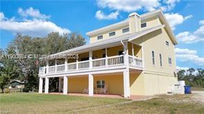 Income-Producing Ranch Estate in Fort Myers – Airbnb & Event Venue Potential
Beautifully maintained 3-story ranch on 2.41 fenced acres zoned AG. The first floor offers a private 3BR/1BA in-law suite, currently a thriving Airbnb earning $200+/night. Upper levels feature spacious open living, natural light, and a wrap-around porch with serene views. Ideal for horses, livestock, or small farming with a pond, chicken coop, and irrigation. Proven event venue for weddings and private parties. Perfect for living, renting, hosting, or farming—this versatile property offers country charm, modern comfort, and multiple income opportunities.