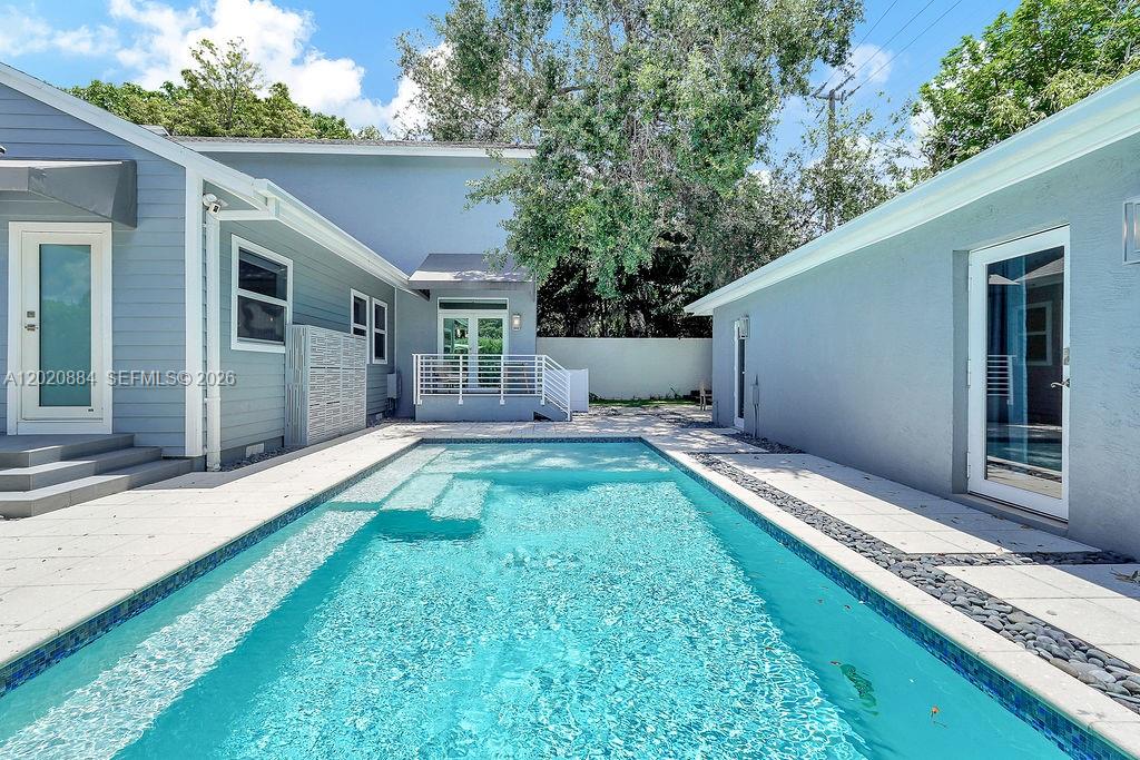 Beautifully renovated 2-story gem in Buena Vista blends timeless charm with modern luxury. Perfectly located just steps from Upper Buena Vista’s trendy shops & restaurants and a short walk to the Miami Design District. Features 4 beds, 3 baths, and a detached guest house (2,438 sqft under A/C). Private master suite with mezzanine & walk-in closet, remodeled kitchen, wood floors, fireplace, impact windows, and high ceilings. Enjoy a serene backyard with pool, built-in BBQ, gas generator & EV charger. Not in flood zone!