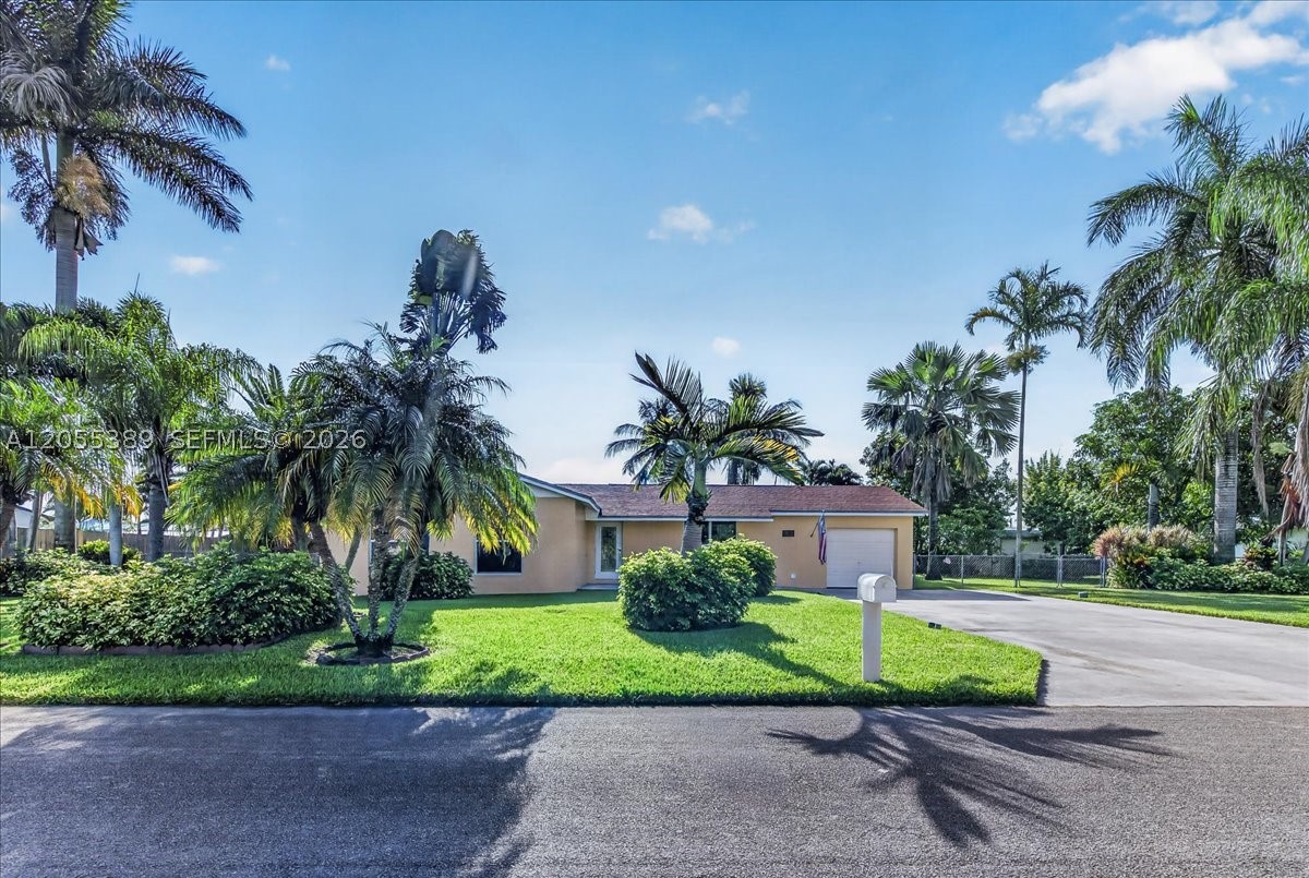Beautifully maintained 4-bedroom, 2-bath home on an oversized 15,000 sq ft lot with mature, tropical landscaping in a quiet, established neighborhood. This lovingly cared-for property—owned by the same family since 1981—features impact windows and doors, updated kitchen and bathrooms, granite countertops, backsplash, stainless appliances, two refrigerators, and a dedicated coffee bar with abundant storage.

Interior highlights include French doors to a spacious 25x15 family room, full laundry room, and excellent flow throughout. The expansive lot offers ample parking plus room for a boat, RV, or future pool. A private backyard oasis with hot tub, privacy fencing, and fruit trees including avocado, mango, carambola, lychee, and coconut palm. Well sprinkler irrigation keeps the grounds thriving.

Conveniently located within walking distance to South Dade Park and South Dade High School, and just minutes from shopping and all major highways. No HOA, No CDD.