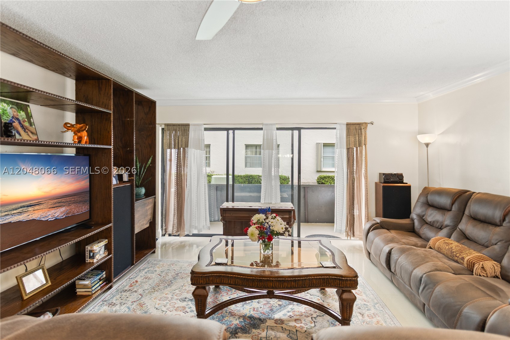 One of the things longtime residents appreciate most about The Laurels is that location within the community matters. This first-floor corner home is tucked into one of its quietest settings, surrounded by mature trees, just a short walk from the amenities, yet away from through traffic. Wake up to birdsong instead of traffic and enjoy the peaceful surroundings from your screened patio.
Offering 2 bedrooms, 2 bathrooms, and 1,019 square feet of living space, this well-maintained home features impact windows, porcelain tile flooring, an in-unit washer and dryer, generous closet space, and assigned parking conveniently located right in front of the unit. A second assigned parking space may also be available. Life at The Laurels extends well beyond your front door. Residents enjoy a large heated pool with a covered deck surrounded by mature trees, a welcoming BBQ area, and a sports center with soccer, tennis, and basketball courts. The community's spacious layout, tree-lined walkways, and limited traffic make it a favorite place for morning walks, evening strolls, or simply enjoying the outdoors. With or without pets. Conveniently located near the Florida Turnpike, US-441, shopping, restaurants, and nearby emergency medical facilities, this home offers the perfect balance of peaceful living and everyday convenience. Some homes are all about upgrades. This one is about something harder to find: peace, privacy, and one of the best locations within the community.
