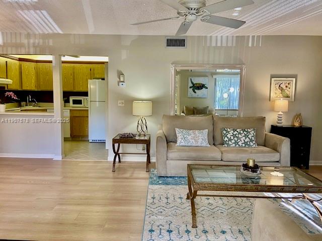 NO CARPET! Fully furnished and move-in ready condo in a desirable 55+ community. Updated 2/2 in 55+ Pine Ridge South IV, located on the 2nd floor, offering added privacy with no upstairs neighbors. Unit includes a full-size washer & dryer, a newer A/C and water heater, and a new refrigerator and dishwasher. Roof replaced in 2024. This unit offers a bright and spacious living/dining area, a screened-in patio with accordion shutters—perfect for enjoying your morning coffee—and generously sized bedrooms, each with walk-in closets. The primary bath has been tastefully updated with a modern shower. Newer A/C and water heater unit, new refrigerator, and dishwasher. The in-unit laundry room features a full-size washer and dryer for added convenience. Enjoy an active lifestyle with amenities such as a large heated pool, spacious clubhouse, bocce ball, shuffleboard, and a scenic walking path around the lake.
