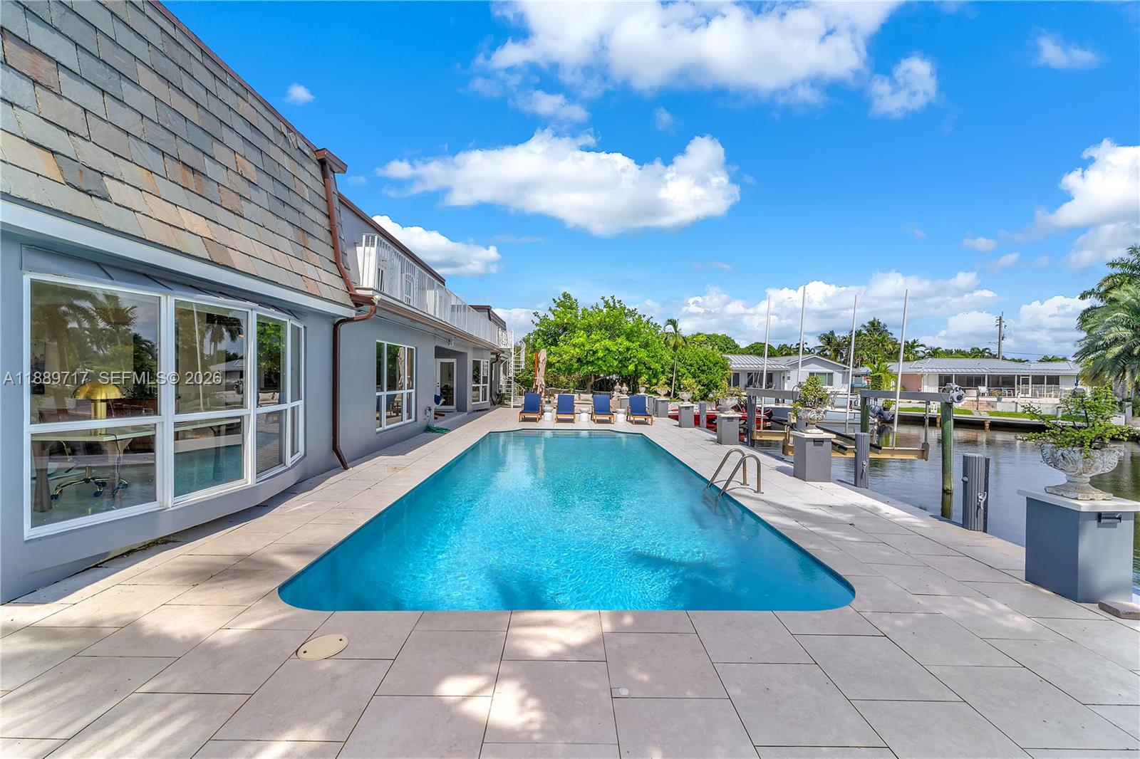 One of the largest waterfront residences in Lighthouse Point, this expansive property offers 6,594 square feet of living space with 7 bedrooms and 6.5 baths, including a separate guest suite with its own full bath and kitchenette, providing a rare level of flexibility for multi-generational living, extended guests, home offices, or a variety of lifestyle needs. Situated on approximately 100 feet along the North Grand Canal, the property features approximately 97 feet of dockage with boat lift, a pool, and generous outdoor entertaining areas. The spacious floor plan is designed for both everyday living and large-scale gatherings, while full impact glass, a renovated primary bath, and numerous updates enhance comfort and functionality. The property has also demonstrated proven rental demand, offering future ownership flexibility. A unique opportunity to acquire one of Lighthouse Point's largest waterfront homes with exceptional space, versatility, and long-term potential. SELLER FINANCING AVAILABLE.