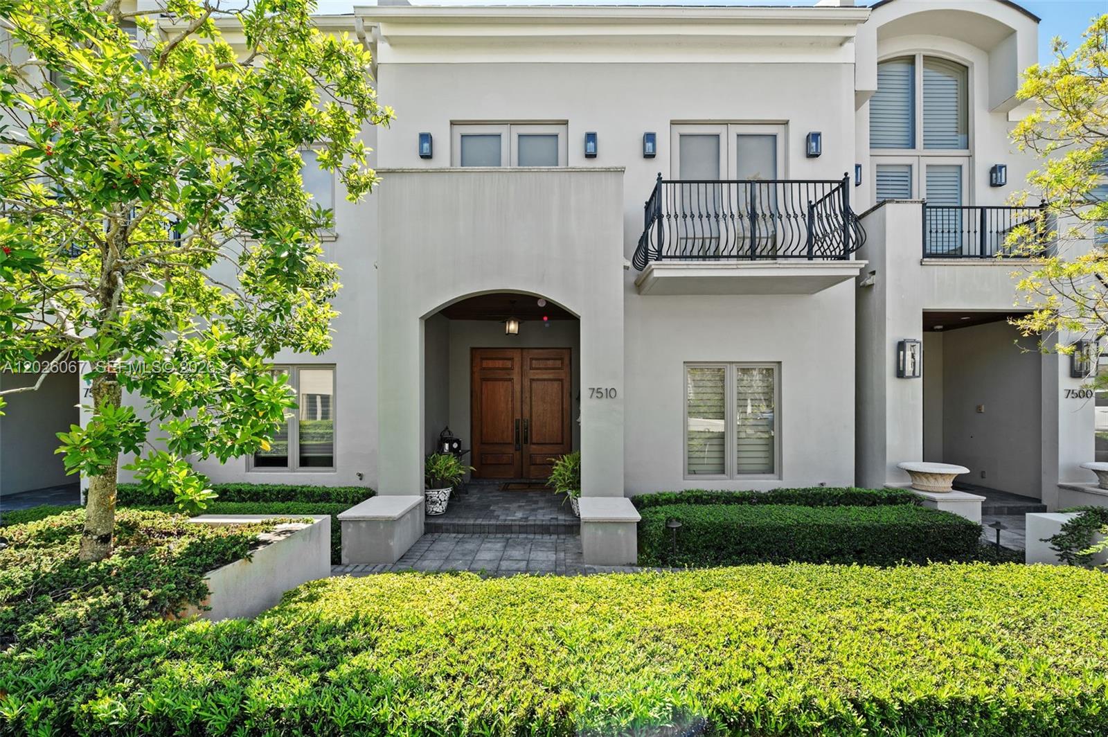 Live the luxury life of ease in the Townhomes at Oak Lane, a gated High Pines community bordering lively, supremely walkable Downtown South Miami. This meticulously maintained home is strikingly appointed with travertine marble & wood plank floors + an elevator to whisk you between all 3 levels, which include a fully finished walk-out basement. Entertain indoors or out, inviting guests to mingle thru distinct formal and casual wings that flow out to a private walled patio adorned with lush, mature landscaping. The secluded primary suite features a large, multi-room spa-inspired bath, 2 large closets & a big balcony. Also boasting impact windows & doors, generator ready, laundry & 4 garage spaces, this home will exceed your expectations. Located in Sunset Elementary School District.
