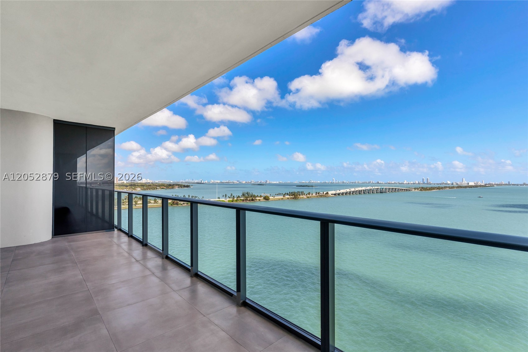 Elegantly and tastefully finished 3-bedroom, 3.5-bath residence with den offering breathtaking water views at One Paraiso, moments from the Design District. A private elevator opens directly into the residence's exclusive foyer, while dual terraces capture both sunrise vistas over Biscayne Bay and sunset views across the Miami skyline. Interiors feature polished concrete floors, floor-to-ceiling windows, European cabinetry, custom closets, and electric blinds throughout. One Paraiso welcomes residents with a striking double-height lobby overlooking Biscayne Bay in Miami's vibrant Edgewater neighborhood, offering resort-style amenities including a full-service spa, two pools, hot tubs, tennis courts, a bayfront fitness center, spinning and yoga studios, a wine room, and party and game rooms.