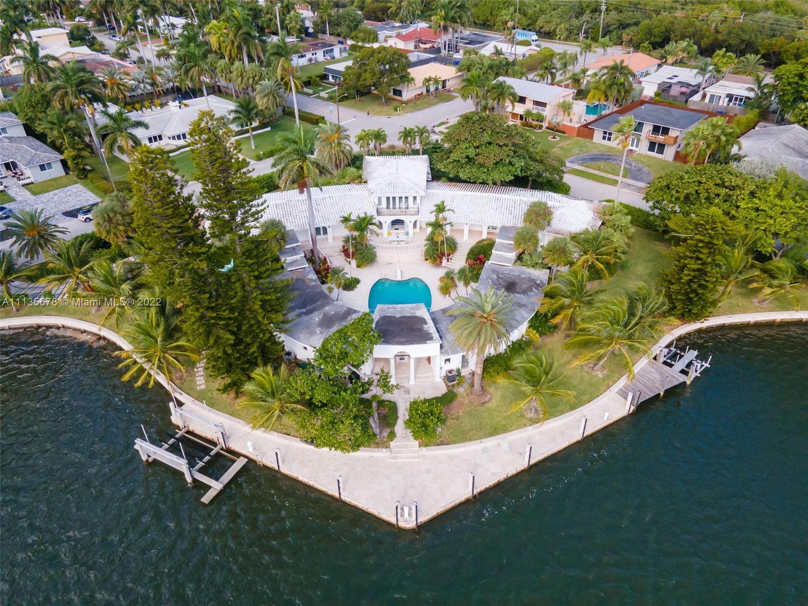 This is the best waterfront property South Florida has to offer @$6M w/450 linear feet of direct water-frontage. Uniquely private elevated nearly 1 Acre Point lot with no direct neighbors. A Yachters dream home with expansive bay views and 185' of dockage complete with 20,000lbs boat lift and lift for 2 Jet Ski's. This Estate has the most breathtaking water views and includes 2 beautifully updated private Villas for your guests, an updated kitchen, 3 car garage, grand 1,300+ Sq ft Owner's Suite, his and hers closet and fully updated bathroom overlooking the stunning water views. The home went through a renovation in 2015  and the sea wall is in good condition. The serene outdoors face the tranquil 450' of waterfront & include a private dock. This Trophy/Unparalleled property will Go Fast!