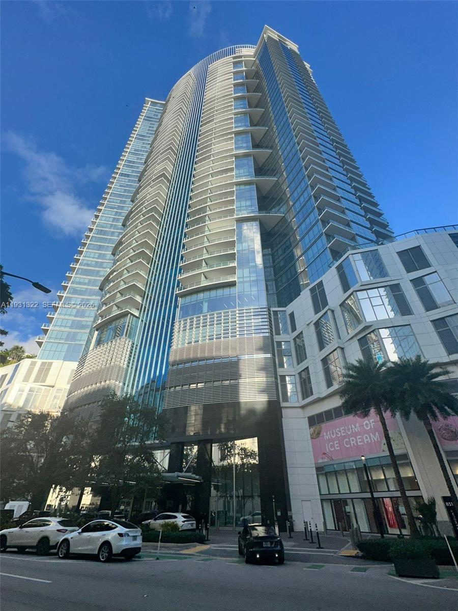 3/4 + fully enclosed den residence in PARAMOUNT MIAMI WORLDCENTER. Enjoy sunrise views from one side and sunset views from the other. Private elevator access opens directly into the unit.  Layout includes an in-law suite with a wet bar and the option for a separate entrance. The home features new luxury vinyl flooring and high-end finishes, including Bosch and Sub-Zero appliances and Italkraft custom closets and fixtures. The unit has 3 terraces totaling approx. 400 sq ft, including additional private terrace off one bedroom. The den has been converted into a fourth bedroom, complete with a custom built-in desk and wine bar. Building has resort-style amenities, including multiple pools, spa, fitness center, squash, golf simulator, movie theater, tennis courts, valet, and guest areas.