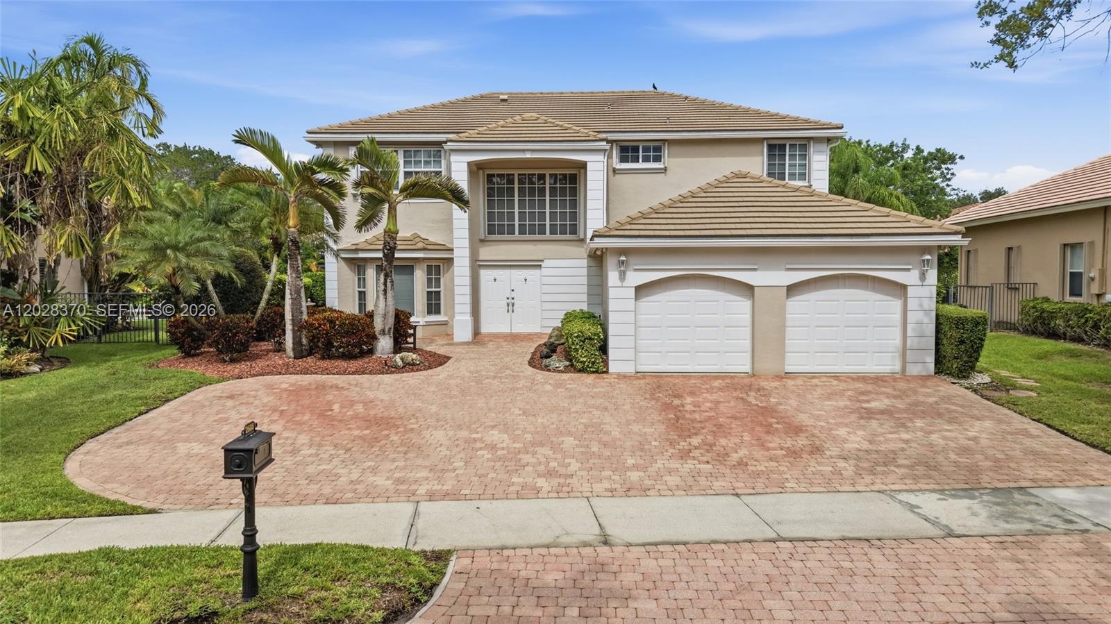 Tucked at the end of a quiet cul-de-sac in the gated community of Weston Hills Country Club, this custom home sits behind a full clusia and arboricola hedge for exceptional privacy, with a large paver driveway and parking for six. Storm-ready from top to bottom with impact-rated windows, doors, kevlar hurricane screens and accordion shutters. The main home opens to a two-story foyer with diagonal porcelain tile throughout the living areas. Formal living and dining room, a family room overlooking the pool, and a renovated kitchen with shaker cabinetry, quartzite countertops, and stainless steel appliances anchor the first floor. Also on the main level are a guest bedroom, full bath, laundry room, and two-car garage. Upstairs, the primary suite features vaulted ceilings, a sitting area, two walk-in closets, and a renovated bath with soaking tub and glass-enclosed shower. Three additional bedrooms share an updated bath. The generator ready two-story addition functions as a private residence with its own entrance, full kitchen, living and dining areas, cabana bath, built-in office and hydraulic elevator leading to a second primary suite with maple floors, wall of closets, and private bath. Outside the screened pool and paver patio feature a large covered area. Additional features include 3 A/C units with UV lights, whole-house alarm, crown molding, fresh paint and step-free entry.