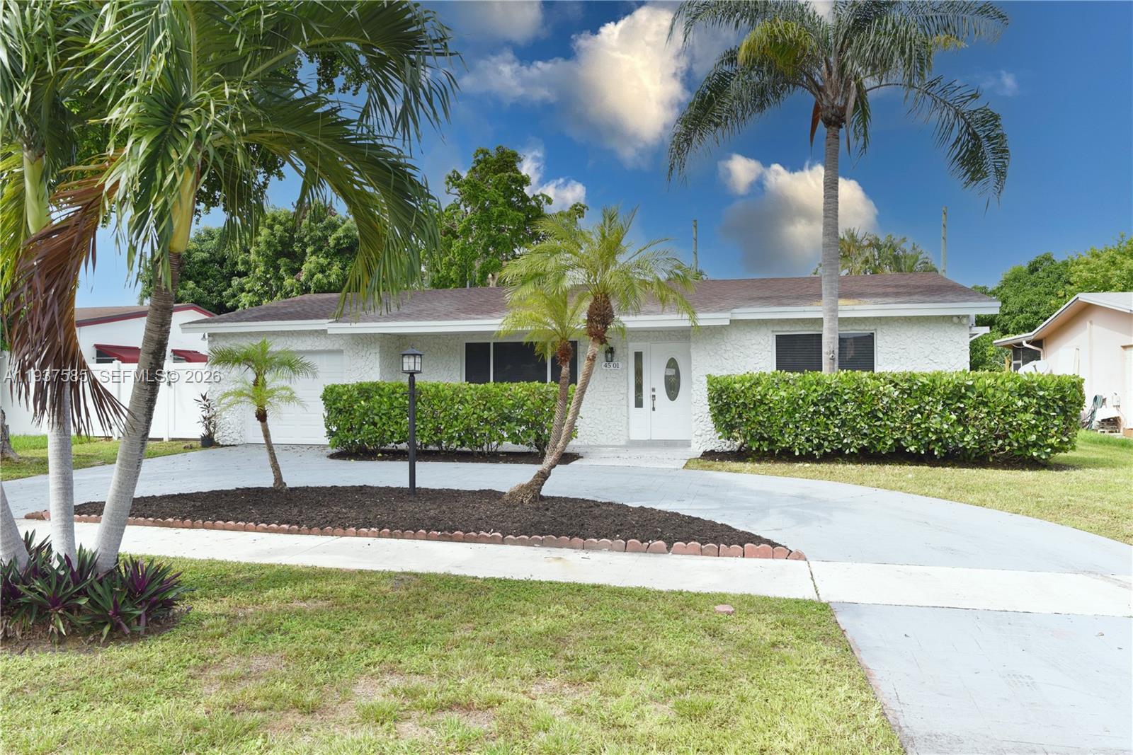 Stunning 4 bedroom, 2-bathroom tropical oasis situated on an expansive and lushly landscaped lot. The open- concept layout features a split-bedroom design for added privacy. This home offers a large spacious kitchen boasting high-quality cabinetry, quartz countertops, and stainless steel appliances. The luxurious master bathroom is adorned with new tile flooring and countertops, ornate dual glass sinks, and showcases a large jacuzzi tub. Skylights in the living area and floor-to-ceiling windows offers breathtaking views of the private pool and tropical landscaping. New roof, floors, impact windows, and an updated kitchen make this home an ideal ready to move in property. Ample parking in circular driveway, as well as fully functioning remote controlled garage. 

No HOA and quiet residential street, close to i95 and only a few minutes away from the beaches. 

Actual living area is 2,360 sq ft including Florida room expansion.

Images are virtually staged with furniture to illustrate the potential of the space. 

Surveillance cameras on property, contact agent for appointment.