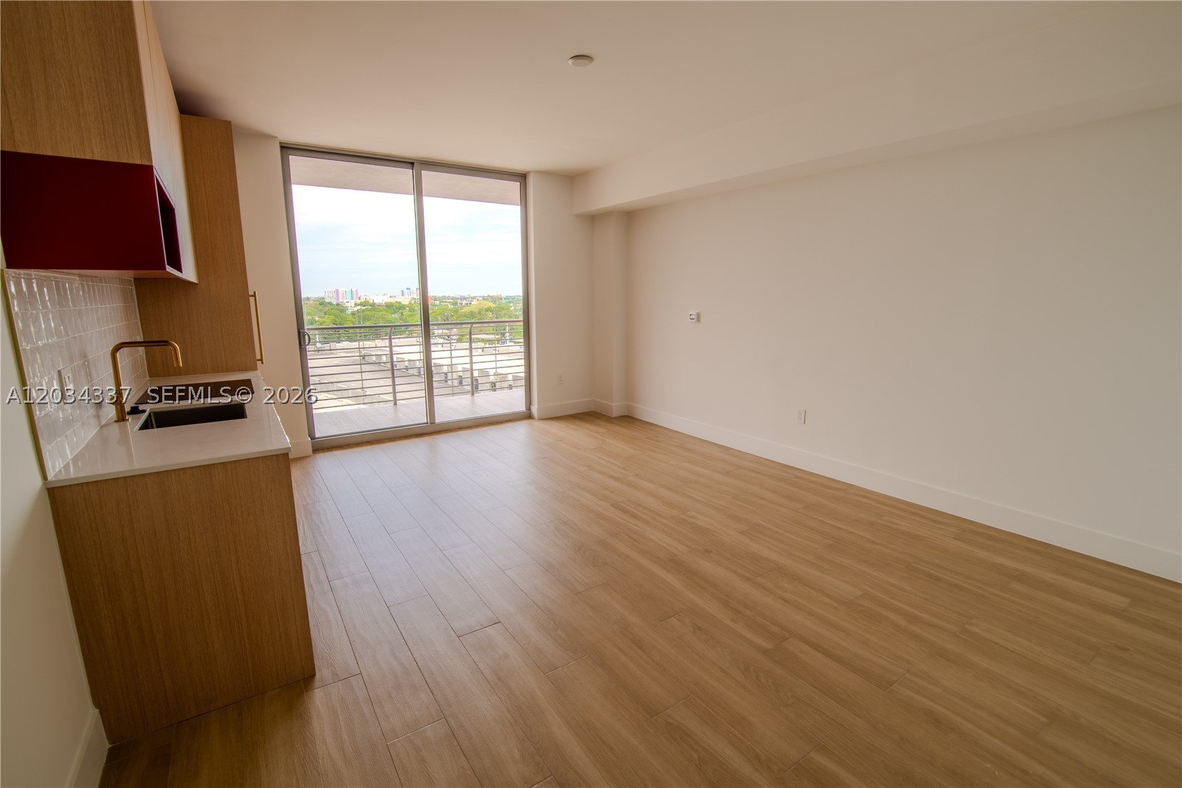 Enviable studio residence at The Standard Residences, Midtown Miami. Brand new construction, never occupied. Wood-look flooring, floor-to-ceiling sliding glass doors, private balcony with guaranteed unobstructed west-northwest views - building design ensures view corridor remains permanently protected. Open kitchen with Bosch appliances, warm oak cabinetry, quartz countertops, white zellige tile backsplash, brushed gold fixtures. Glass-enclosed double rain-head shower, designer gold hardware throughout. In-unit stacked washer/dryer. Access to 34,000 sq ft of curated amenities including rooftop pool deck, multi-concept social lounge, and pickleball/tennis court - each space distinctly designed. The Standard brand, Midtown Miami's internationally recognized lifestyle address. Walking distance to Wynwood Arts District, Design District, and minutes to Brickell financial corridor. Credit check and verifiable income required. Association application required.