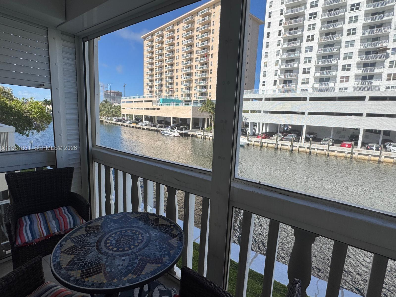 Beautifully maintained waterfront residence in the desirable Monticello Building, nestled within a prestigious private island community and surrounded by multi-million dollar homes. This bright and inviting unit features an open kitchen with a convenient pass-through to the dining area, seamlessly connecting to a spacious formal living and dining room combination—perfect for comfortable everyday living and entertaining.

Tile flooring runs throughout the home, adding a clean and cohesive feel. The spacious one-bedroom layout includes an updated bathroom with wood cabinetry and a glass-enclosed shower. Enjoy peaceful mornings or relaxing evenings on the large screened-in balcony with roll-down shutters, perfectly positioned with east-facing exposure and tranquil water views.

Ideally located just steps from the building’s pool, this residence offers the charm and privacy of island living while being set in a highly sought-after and prestigious neighborhood.