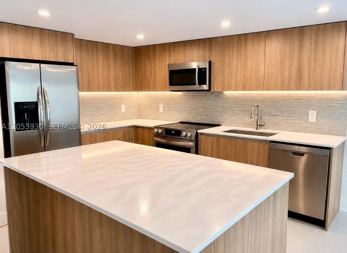 Dream Home in Hollywood!
 Beautifully renovated townhouse in the desirable Villas of Sheridan community, offering 3 bedrooms, 3 full bathrooms, and 1,830 sq ft of spacious living.
This move-in-ready home has been extensively updated with brand-new flooring throughout, a completely remodeled kitchen, and fully renovated bathrooms. The modern kitchen features new cabinetry, quartz countertops, designer backsplash, and stainless-steel appliances, creating the perfect space for cooking and entertaining.
The bright, open-concept floor plan is complemented by smooth ceilings with no popcorn. The oversized primary suite offers a walk-in closet plus two additional closets, providing exceptional storage. A generously sized second and third bedrooms and an additional full bathroom add comfort and flexibility.
Step outside to your private patio with a garden area, ideal for relaxing or entertaining family and friends.
Residents of Villas of Sheridan enjoy outstanding amenities, including a renovated clubhouse, swimming pool, and tennis courts. The association fee covers roof maintenance, water, trash, insurance, and more.
Ideally located near I-95, this home is within walking distance of shopping, restaurants, parks, and places of worship. Conveniently close to A-rated charter schools, major highways, Fort Lauderdale-Hollywood International Airport, and the beautiful South Florida beaches.
Pet-friendly community. 
Schedule your showing today, before it’s gone!