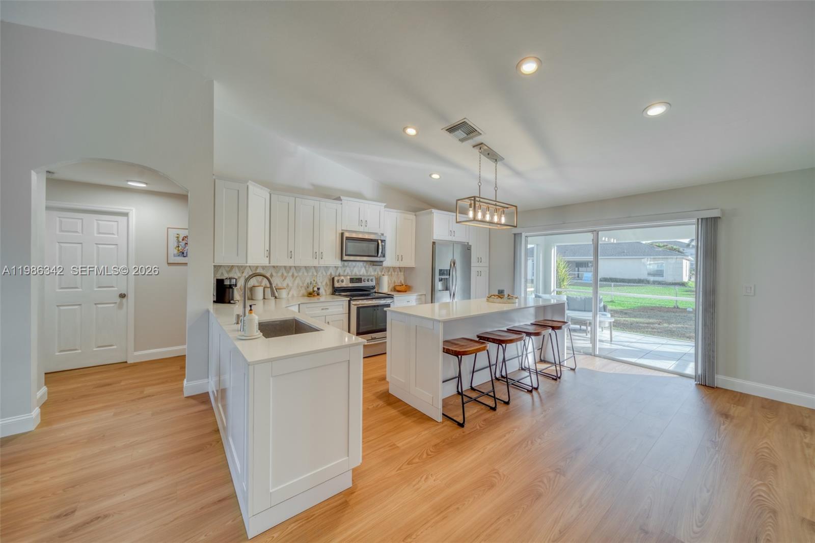 $5,000.00 Seller's Contribution to Buyer's Closing Costs....Welcome to this carefully maintained Home, located in the beautiful surf side area. Impact windows, Stainless steel appliances, roof was replaced in 2018, new gutters and soffit 2023, completely fenced in backyard 2023, spacious screened lanai 2023, 2 car garage with wifi garage door opener 2024. NEW KITCHEN 2025. NEW FLOOR 2026.House is sitting on 10,672 sqft elevated lot that has never flooded. City water and sewer, all assessments and taxes paid. in addition property has a working well water for irrigation or other use. Close to top rated schools. move-in ready..!! Bring your Buyers...!!!