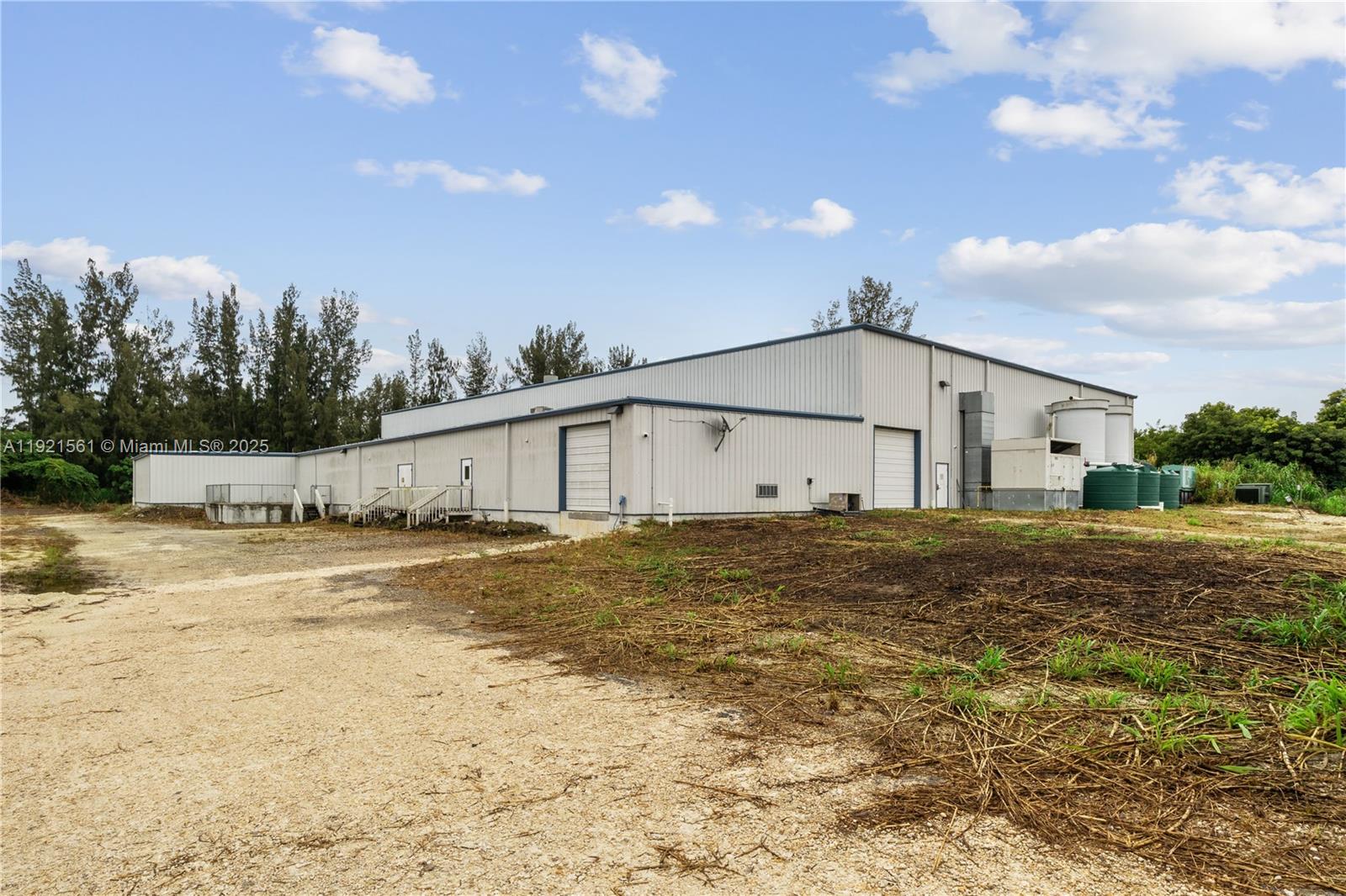 Discover an exceptional opportunity in this 2015, 35,796 sqft insulated steel building on 5-acre lot (4 useable). Investor or Owner Users welcome. It offers significant benefits including 26 ft high ceilings, a secure fenced lot, plenty of parking, powerful electrical systems, security system and lights. Electrical 800-amp 480/277 v three phase & (2) 400 amp 120/240v 3 phase system. Two dock height doors and three drive up doors. Additional white hurricane impact tents add an additional 6000-7000 sqft of useable space, rented MTM. With its prime location near the Turnpike, Homestead Air Base, and major distribution centers, your business will have unparalleled logistics access. Ample outdoor storage. Information deemed accurate but must be verified by consumer. Also for lease, can be divided.