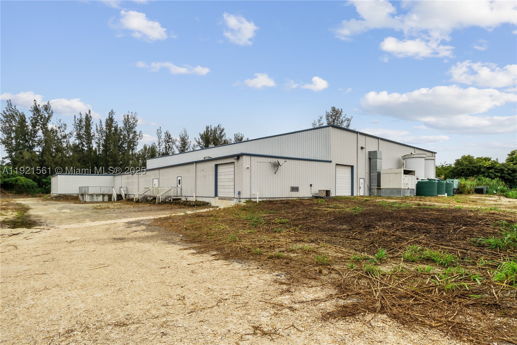 Discover an exceptional opportunity in this 2015, 35,796 sqft insulated steel building on 5-acre lot (4 useable). Investor or Owner Users welcome. It offers significant benefits including 26 ft high ceilings, a secure fenced lot, plenty of parking, powerful electrical systems, security system and lights. Electrical 800-amp 480/277 v three phase & (2) 400 amp 120/240v 3 phase system. Two dock height doors and three drive up doors. Additional white hurricane impact tents add an additional 6000-7000 sqft of useable space, rented MTM. With its prime location near the Turnpike, Homestead Air Base, and major distribution centers, your business will have unparalleled logistics access. Ample outdoor storage. Information deemed accurate but must be verified by consumer. Also for lease, can be divided.