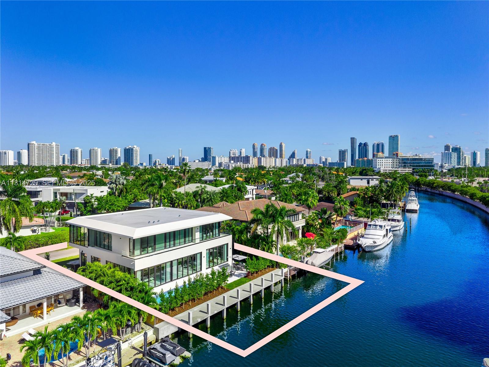NEW BUILD ORGANIC MODERN WATERFRONT ESTATE IN THE HEART OF EASTERN SHORES! Modern Tropical Oasis in Light Natural Wood Encompassing 5 Bedrooms + 5 Baths + Powder Room in 5,796 Interior SF on 8,800 SF LOT with 80 FT of Waterfrontage. Enter into Open Floorplan with Calacatta Marble on Ground Floor. Enjoy Expansive Entertaining Spaces + Wine Cellar & Direct Water Views. Organic Wall Textures Throughout. Staircase Leads to Spacious Primary Suite Overlooking the Water. Custom Italian Kitchen Accented with Organic Light Wood with Oversized Island Countertop. Primary Bath with Hansgrohe & Duravit Fixtures + Rainshower. Deck Perfect for Entertaining with Heated Pool & Summer Kitchen. Minutes Away from Sunny Isles Beach, Aventura Mall, Dining & Oleta River State Park. Delivers Q2 of 2025.