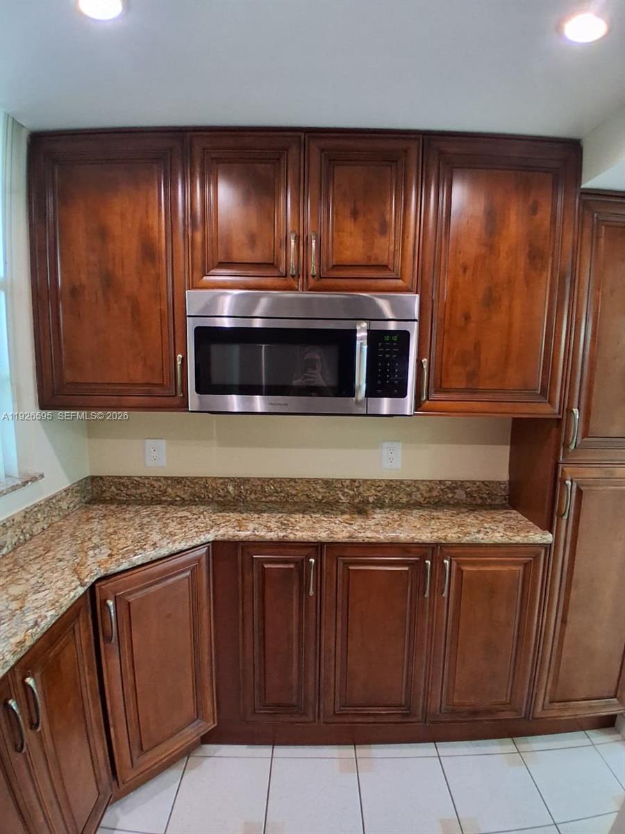 Great Community! Serene views! Private Guard Gated Community.  Ready to move in! Tile floors throughout, this unit has a one full bathroom and a half bathroom, tastefully decorated. Beautiful Kitchen cabinets, granite countertops and updated appliances. 55+ community. Great walking areas, swimming pools throughout! Guest parking space in front of this building allowing short walk to the bldg. Washer & Dryer on the same floor! Small bowling ally and lots of amenities in the club house!