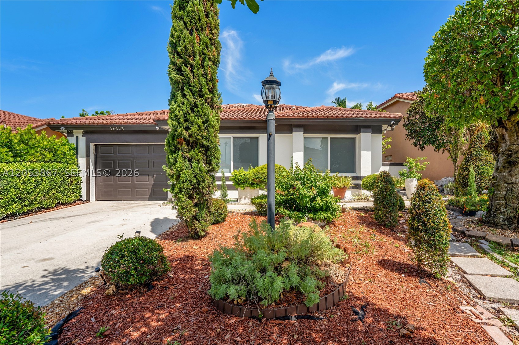 Stunning, fully renovated 3-bedroom, 2-bath home offering 1,692 sq ft of modern living in a sought-after gated Miami Gardens community. This move-in-ready gem is loaded with premium upgrades: hurricane-impact windows throughout, a whole-house reverse osmosis system, smart home technology, a full irrigation system, and a sleek island style kitchen with Samsung stainless steel appliances. Enjoy custom built-in closets and a spacious walk-in closet, plus a large covered patio with awning made for entertaining. A beautifully landscaped front garden and the fully fenced backyard is a private oasis featuring patio garden including mature fruit trees — avocado, soursop, cherry, and sour orange. Residents enjoy resort-style amenities including a sparkling pool, basketball court, picnic area, children's playground, and 24/7 security. A rare blend of luxury, comfort, and location — schedule your private showing today!