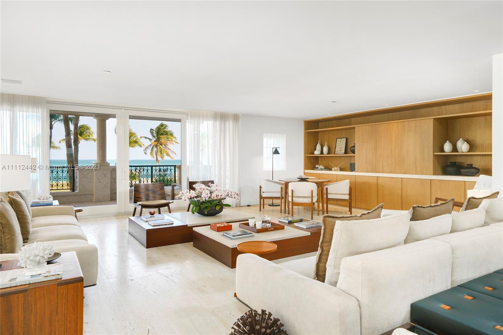 This expertly renovated sleek and modern 2nd floor Oceanside unit offers 3,580 SF and a large wrapping terrace with direct beach and ocean views. Exquisite Italian Travertino Navona marble and tan oak floors adorn this unit with open extended living room & dining area, custom millwork, and beautifully designed minimalist chef’s kitchen boasts a Navona marble island with seating, custom cabinetry, and top-of-the-line Gaggenau appliances. The spacious principal suite features a den/office space, private balcony and amazing principal bath with voluminous walk-in closet, a soaking tub, and large walk-in shower. The other 2 bedrooms are each uniquely designed, and well-proportioned with en-suite bathrooms. All hurricane impact resistant windows and doors. 5-Star Fisher Island amenities.