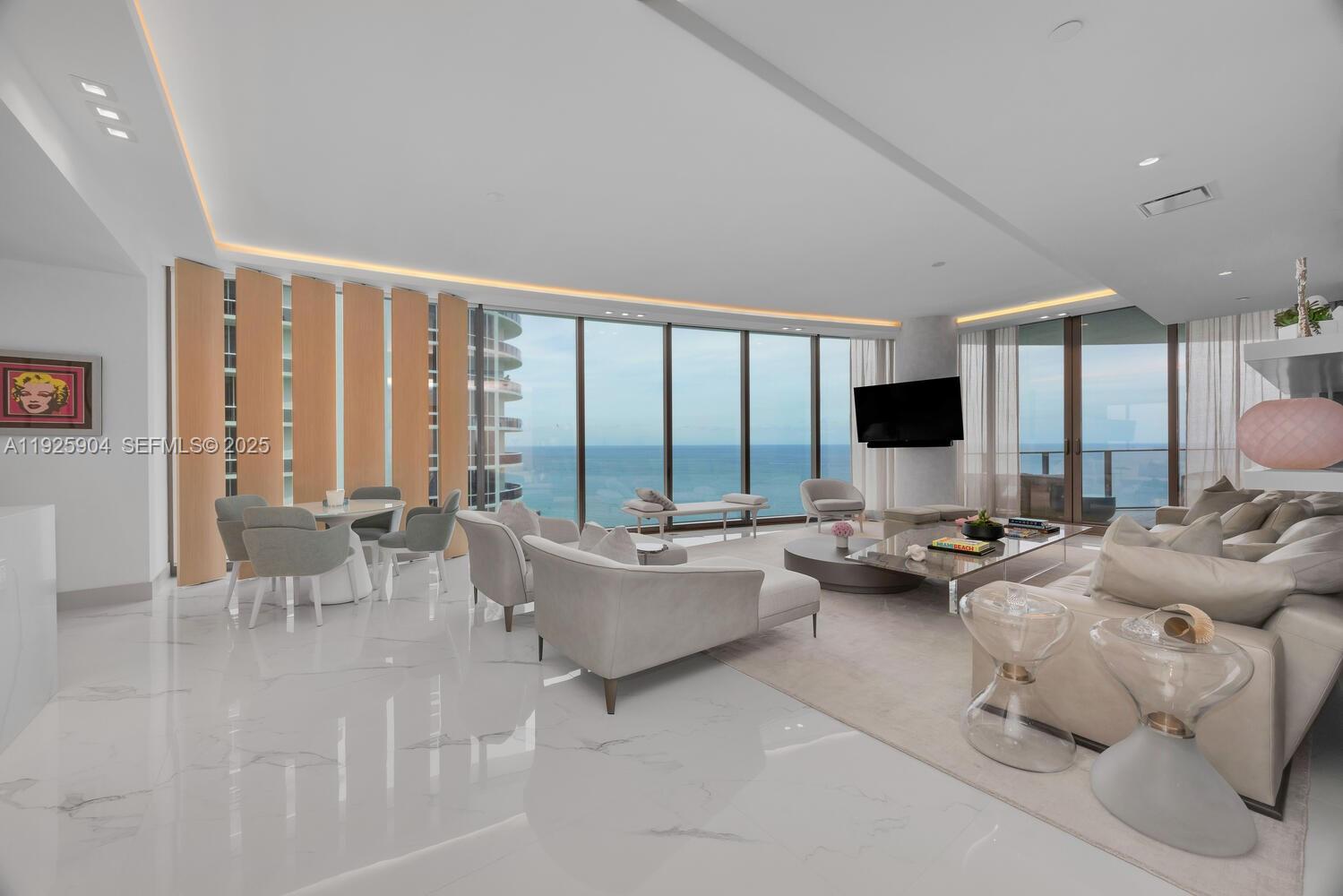 Welcome to Residence 3701 at the Ritz-Carlton Residences, Sunny Isles Beach, an exceptional oceanfront offering with 4 bedrooms & 4.5 bathrooms.Designed by renowned architectural firm Arquitectonica with interiors by Italian designer Michele Bönan, this high-floor residence showcases panoramic views of the Atlantic Ocean, Intracoastal Waterway, & Miami skyline through floor-to-ceiling glass.The gourmet kitchen is equipped with top-of-the-line Gaggenau appliances, custom cabinetry, & sleek countertops, while each bedroom offers a private en-suite bath. The primary suite is a tranquil retreat with spa-inspired bathroom & stunning water views. Residents enjoy five-star Ritz-Carlton amenities including beach service, resort-style pool, fitness center, spa, concierge, valet, & 24-hour security.