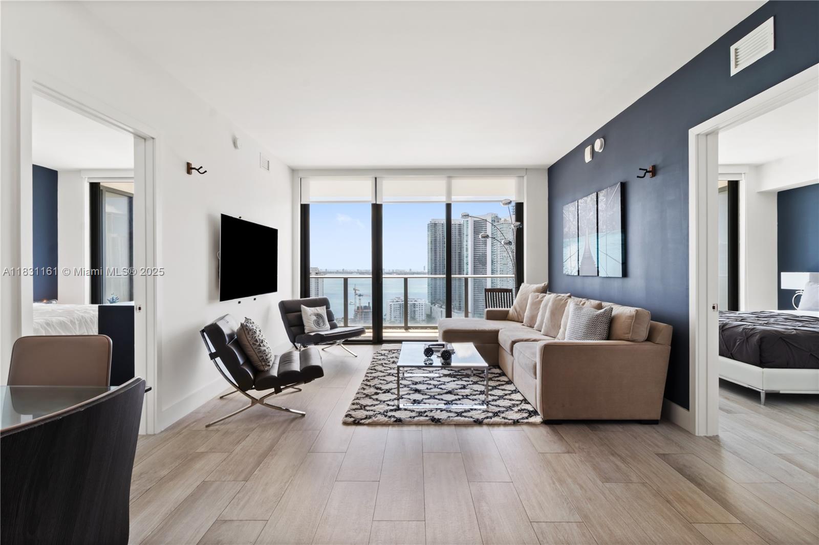 Available for Rent, either short-term 30 days minimum and long-term 1 year lease, this stunning condo in Hyde Midtown offers breathtaking sunrise views of Biscayne Bay and the Miami skyline from every room. Featuring 2 bedrooms, 2 bathrooms, and a versatile den, the unit is fully furnished and thoughtfully designed for comfortable, upscale living.

Enjoy resort-style amenities including 24/7 concierge services, a full-service spa, state-of-the-art fitness center, pool, tennis court, and an on-site bar-restaurant. Perfectly situated in a walkable neighborhood just steps from the Miami Design District, and only minutes from South Beach and the airport. Experience luxury, convenience, and vibrant city living all in one place. Call listing agent(s) for showing!