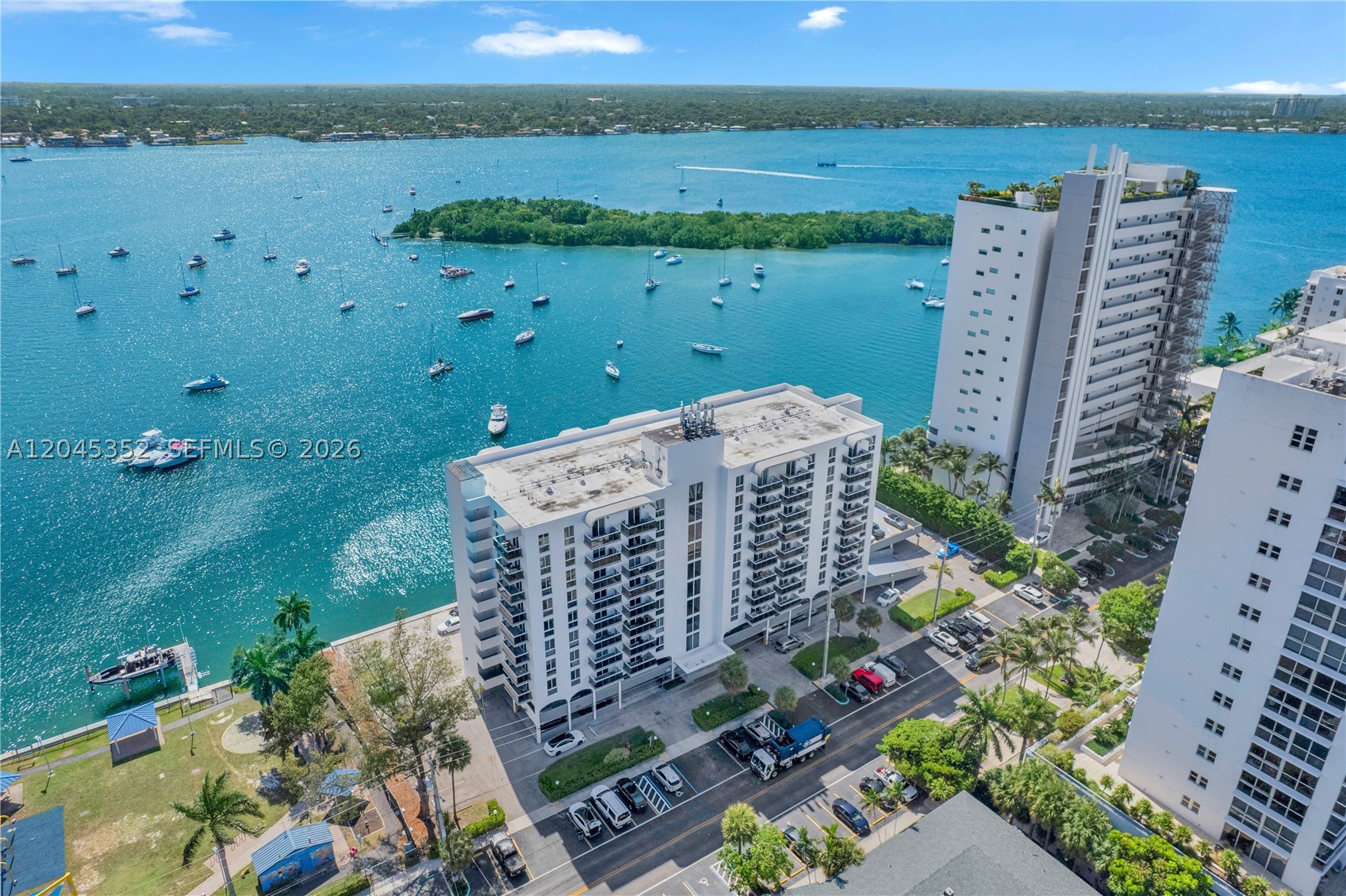 HOA just reduced! Assessment fully paid! Move right in and enjoy a lifestyle of effortless comfort. Waterfront living at its finest in this pristine  2/2 in Harbor Island, North Bay Village. Stunning west-facing views stretch over Pelican Harbor to the Downtown Miami skyline. This meticulously kept unit is filled with natural light all day. Generous living spaces & oversized bathroom. Bathroom upgraded with floor-to-ceiling marble tile. One of the few units featuring a full-size washer + dryer. Ample storage throughout, including a walk-in closet & deeded storage cage on the same floor. The Islander has been beautifully updated and has passed its 50-year recertification, offering lasting value and peace of mind. Peaceful building with amenities such as a gym, waterfront pool, lounge areas, a new
sunset deck, BBQs, guest parking, plus bike and kayak storage. Includes one deeded parking space