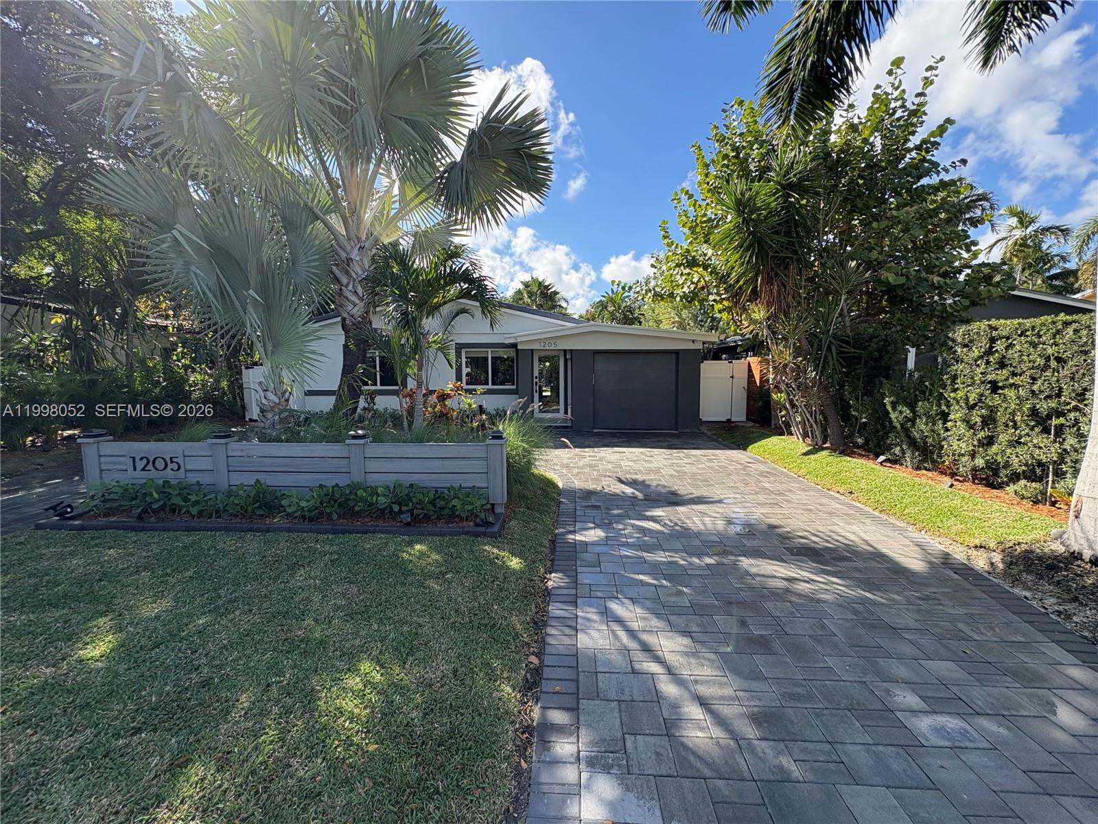 Spectacular fully remodeled modern residence, offered furnished and truly move-in ready. This exceptional home features 3 bedrooms, 2 beautifully updated bathrooms, and a sleek designer kitchen equipped with a 2025 Samsung smart refrigerator, KitchenAid gas/electric oven, and Whirlpool dishwasher. Interior highlights also include impact windows, elegant European 4x4-foot flooring, and a stylish bar with wine cooler.

The outdoor space is a private resort-style retreat, thoughtfully designed for entertaining and relaxation, with a modern PVC deck, expansive gathering area, LED lighting, and a semi-covered gallery featuring gas and wood grills, jacuzzi, and sauna. This gallery also offers the potential to be enclosed with impact windows, creating approximately 400 additional square feet of interior living space.

The air-conditioned garage provides excellent flexibility and can be used as a gym, studio, or multipurpose space. The property also offers a spacious driveway with room for 3 to 4 vehicles. Ideal as a primary residence, second home, vacation property, or income-producing rental, this is a rare turnkey opportunity with exceptional lifestyle and investment appeal.