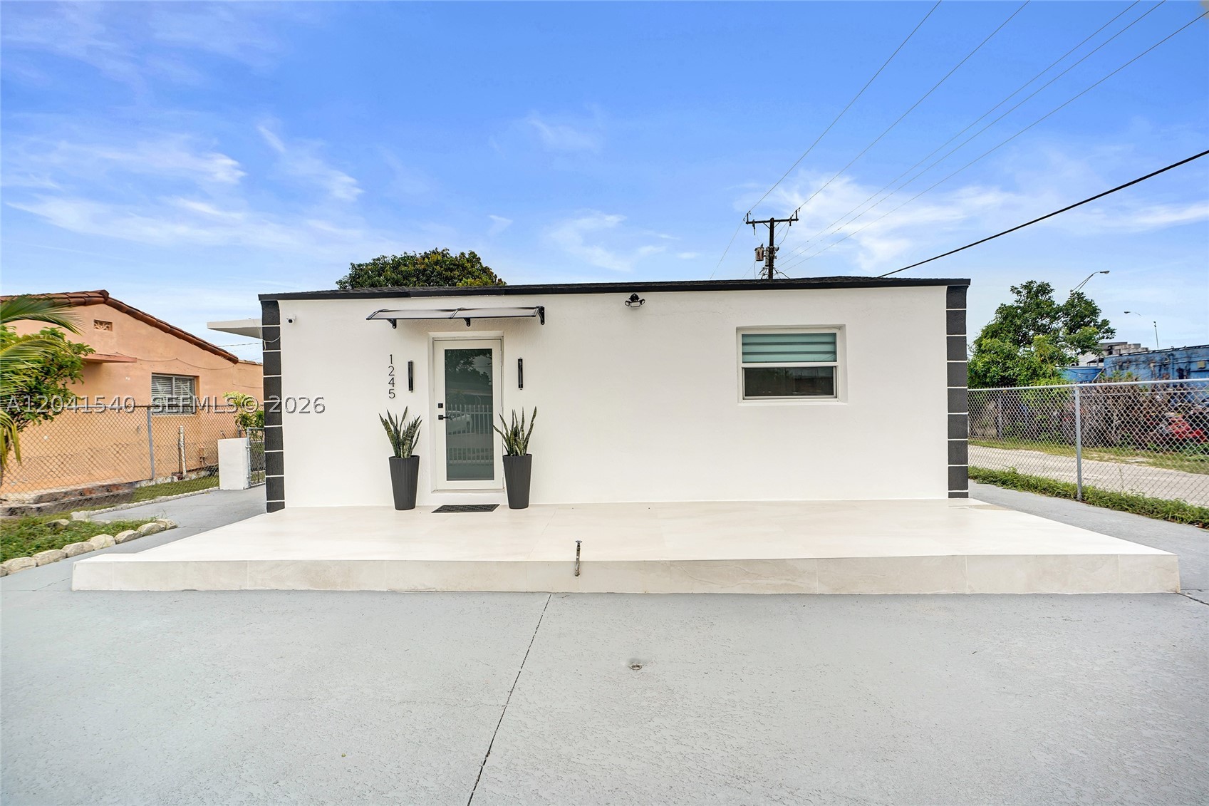 Fully renovated home featuring a brand-new roof, impact windows and doors, new stucco exterior, and a newly tiled front porch. Interior includes updated bathrooms with modern finishes and glass shower doors, porcelain flooring throughout, and a renovated kitchen with quartz countertops and new appliances.

Additional upgrades include new A/C, new water heater, and new washer and ventless dryer. Exterior offers a spacious backyard, freshly painted fence and driveway, and a screened-in patio for added comfort.

Corner lot home with no direct neighbor on one side for added privacy. Rear alley access provides extra convenience and potential space for parking boats or trailers. Move-in ready with all major systems and finishes updated.