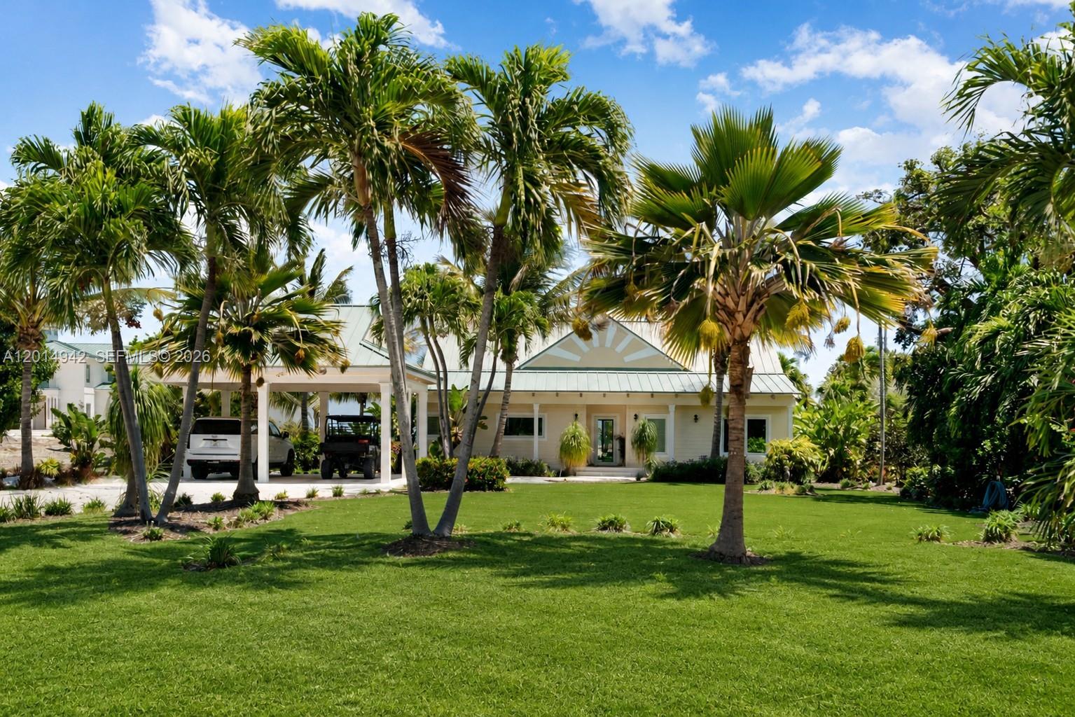 Set along prestigious Millionaire’s Row in Tavernier, 88835 Old Highway presents a rare waterfront offering spanning over 3 oceanfront acres, plus an additional acre with a protected private boat basin. Blending privacy, expansive land, and future potential, this exceptional property embodies refined coastal living in the Upper Keys. Completed in 2022, the residence features 3 bedrooms, 2 bathrooms, and approximately 1,500 square feet of thoughtfully designed interiors with impact windows and doors, rich hardwood flooring, a steel metal roof, and a designer kitchen outfitted with premium Viking appliances. Outdoor spaces are designed for effortless luxury, featuring shell stone porch flooring, covered parking, lush tropical landscaping, and low-maintenance turf. The estate consists of three separate parcels, including a buildable lot (Lot 1A), the current homesite (Lot 2A), and a natural hammock parcel (Lot 3A) that serves as a permanent privacy buffer, enhancing the property’s exclusivity and tranquility. With direct access to a private boat basin and the rare opportunity to create a custom waterfront compound, 88835 Old Highway offers an unmatched combination of immediate enjoyment, development flexibility, and long-term value in one of the Florida Keys’ most coveted waterfront enclaves.