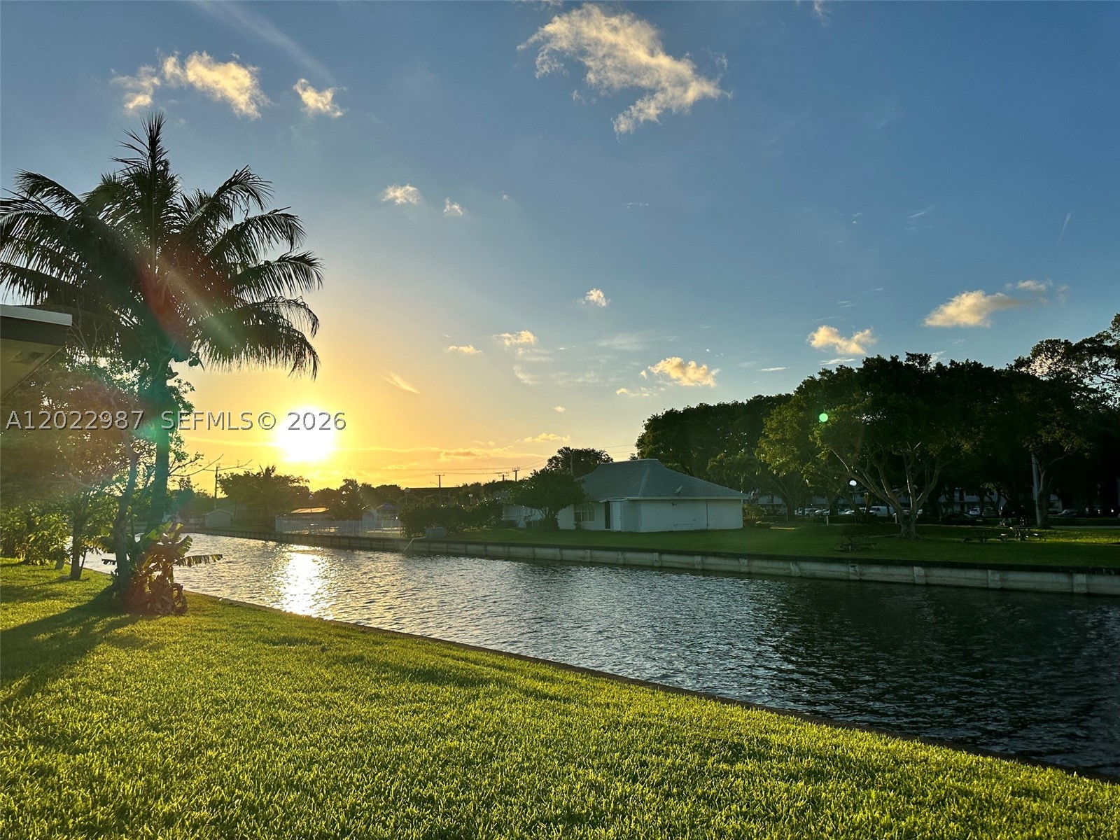 Wake up every morning to peaceful water views in this beautifully maintained home located in the desirable Sunset Isles section of The Mainlands, a vibrant 55+ community in Tamarac. Enjoy coffee on your screened patio overlooking the canal while taking advantage of a low-maintenance lifestyle close to shopping, dining, and major highways. This spacious 2-bedroom home features tile flooring throughout, a bright and cheerful interior, a newer roof (2020), and A/C (2022), giving buyers peace of mind on two of the home's biggest expenses.
The community welcomes pets and motorcycles and offers resort-style amenities including a clubhouse and pool, all within walking distance. Lawn care, sprinkler maintenance, exterior painting, and roof cleaning are included in your monthly low-maintenance fee, making it easy to spend less time maintaining and more time enjoying South Florida living. Also, I'm a lender, and if you're wondering what the payments would be, I can help you with that, too.