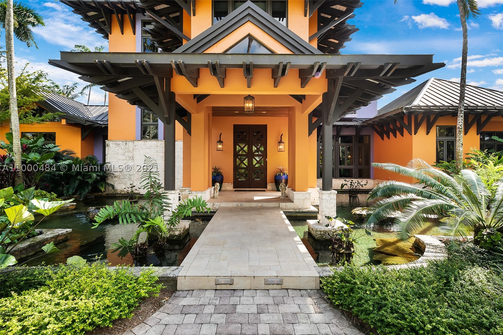 Sensational 10-acre+/- estate in the Redland is filled with local and exotic flowering trees and plants. Artistic entry gates welcome all and foretell the enchantment that awaits as you follow the road past two sizable koi ponds up to the main house. Designed by Charles Harrison Pawley the main house offers coffered and vaulted ceilings, Brazilian cherry floors and large living areas including the office/family room and a wonderful kitchen with top-of-the-line Wolfe and Sub-Zero appliances. Take the stairs or the elevator up to the master suite offering his/her closets, luxurious master bath and a screened-in porch overlooking the pool and waterfall. Additional features include a detached 1b/1b Guest Cottage, entertainment pavilion, another 3b/2b staff house, and 80KW full house generator.
