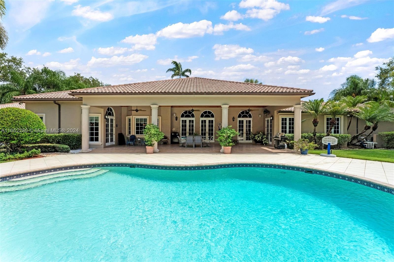 Located in the heart of Coral Gables, this magnificent 5 BD, 4 BA, 5,849 SF residence, is in close proximity to great schools, fine dining, shopping, beautiful parks and the best hospitals. Minutes from Coconut Grove, South Beach and the airport, this home has a 36,450 SF lot, with plenty of room for entertaining, outdoor dining and a yard for children to play. Unique to the area a 1-story home with volume ceilings, 4-inch wood plank floors, gourmet kitchen and a gracious family room including a wet bar and fireplace. Additionally, there is a lovey living and dining room, home office, large primary suite with 2 walk-in closets, 3-car garage, impact windows and doors. The house opens to a breeze filled covered patio, overlooking the pool and garden offering additional entertainment areas.
