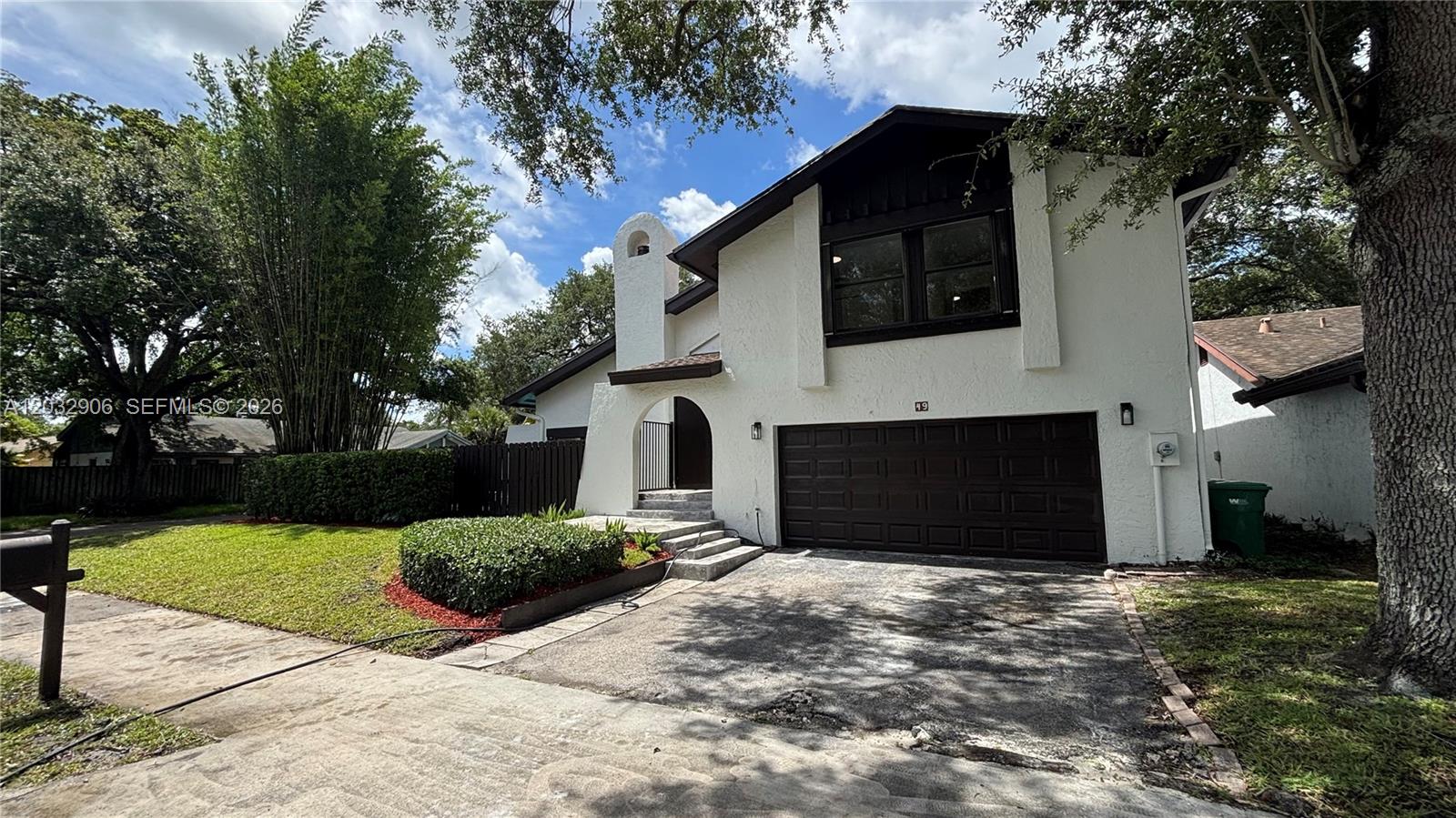 Welcome to 49 Forest Circle, a stunning 4-bedroom, 3-bathroom corner property nestled in the heart of Cooper City, FL. This beautifully updated two-story home offers an inviting open floor plan with high vaulted ceilings and exposed wooden beams that draw in abundance of natural light. The spacious living area features a charming brick fireplace, seamlessly leading into a fully remodeled kitchen equipped with contemporary cabinetry, crisp white countertops, and modern stainless steel appliances. Upstairs and throughout, enjoy sleek new flooring, ample bedroom layouts, and completely upgraded modern bathrooms. The expansive master suite includes a massive custom walk-in closet and a luxurious double-vanity bath. Step outside to a private, fenced backyard oasis complete with a sparkling in-ground pool, mature landscaping, and plenty of space for outdoor entertaining. A spacious two-car garage and a large utility room complete this turnkey home. A perfect blend of style and function in a highly desirable neighborhood!
