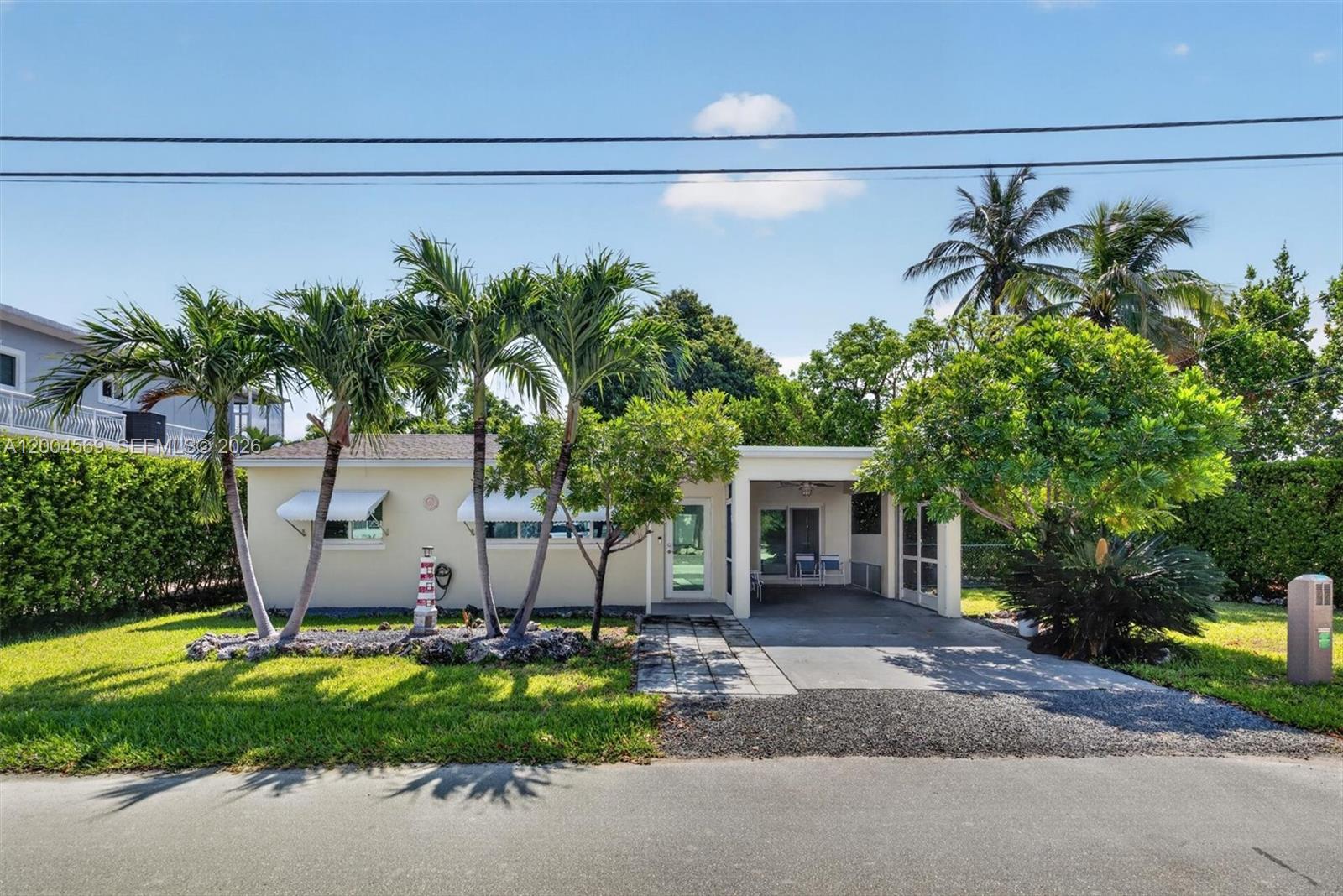 Charming Key Largo Retreat Near the Water... taking in the Bay Breeze. Just under an hour from Miami, discover this picture-perfect “dollhouse” nestled on sought-after Ocean View Blvd in Key Largo. Surrounded by magnificent estates and located near world-famous Snappers, this property offers the perfect blend of charm, location, and opportunity. Set on a 5,780 SF lot , this impeccably updated and maintained home features beautiful terrazzo floors, newer A/C, newer washer and dryer, newer refrigerator, and hurricane-impact doors and windows. Offering both comfort and peace of mind. The spacious yard provides ample room for a boat, mobile home, or future expansion, with covered garage parking already in place. Whether you envision adding a pool, extending the home, or enjoying it just as it is, the possibilities are endless. This Key Largo gem is ready to welcome its next owner. Your slice of the Keys lifestyle awaits.