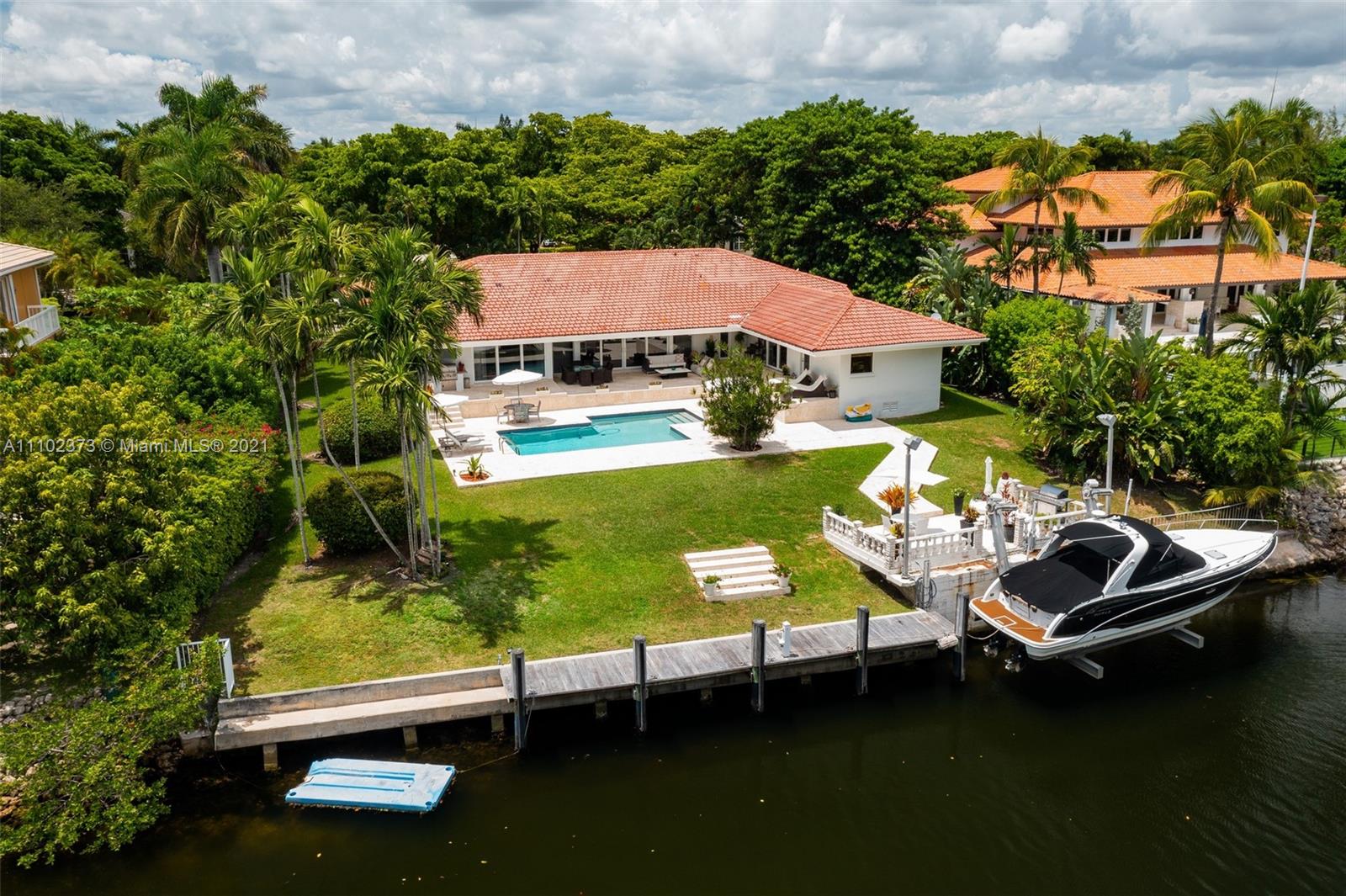 Gorgeous one-story waterfront home nestled in the prestigious gated community of Cocoplum. Living room, family room and master bedroom open to a beautiful private garden, a heated pool and the waterway. With a 1,178sf pool patio, 2 summer kitchens and direct access to the ocean. This Miami dream home has 118 feet of waterfront with 50 ft. private dock plus a 40 ft. boatlift and offers a spacious living room and family room with hurricane windows and electric drapes, a modern Italian kitchen with custom-made Italian cabinets, white stone countertops, and top-of-the-line appliances, master suite with sitting area, walk-in closet, maid’s bedroom/bath, laundry room.  This home sits on a 17,644sf lot with 7 beds, 4.5 baths and is ready to entertain boat aficionados.