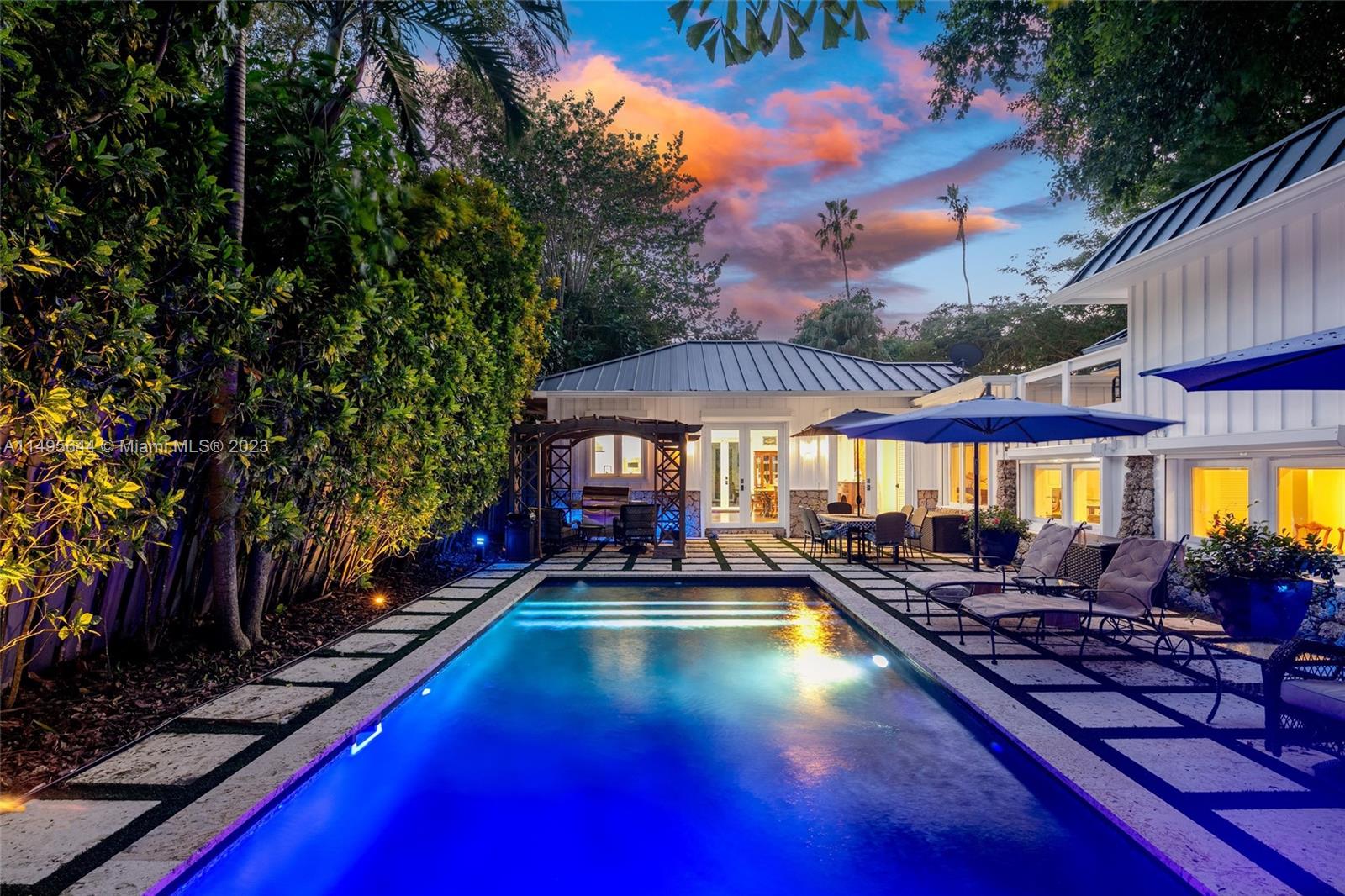Nestled beneath the oldest Banyan Tree in Florida, in the heart of Coconut Grove, the stylish Banyan House offers a tropical oasis with tranquil landscaping. Renovated in 2012, the estate features gourmet kitchen, Viking+SubZero appliances, wine cellar, generator, and more. Naturally lit south facing kitchen w breakfast table, formal living room, dining room w/ wet bar, spacious family room and two bedrooms w/ ensuite bath on ground level. Second floor expansive master suite w/ office, two bedrooms w/ ensuite bath, spacious balcony. Resort-style backyard offers a pool, courtyard, and pathway winding around the Banyan Tree. Additional feats. incl. a coral rock fireplace, impact windows/doors, metal roof, & 2-car garage. Walking distance to Cocowalk Mall and top private schools.