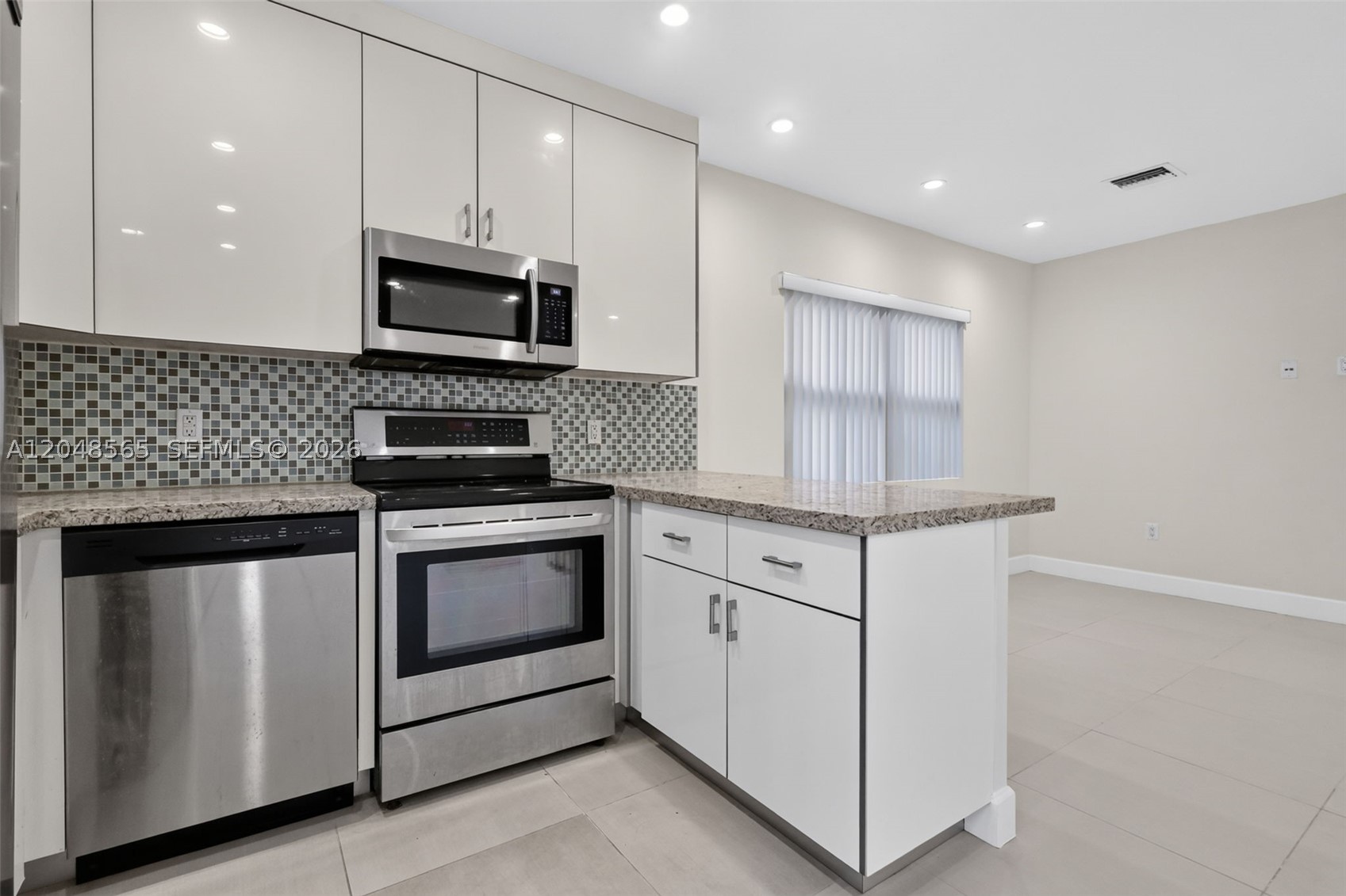Beautifully renovated 1 bed/1 bath apartment in a boutique 4-unit building, tucked away on a quiet, tree-lined street in North Miami. This turnkey unit has been substantially remodeled with a modern, open-concept layout that maximizes natural light and living space.
The kitchen features stainless steel appliances, granite countertops, a decorative mosaic tile backsplash, and glossy white cabinetry with ample storage, all open to the spacious living/dining area. Porcelain tile flows throughout the entire unit for a clean, contemporary feel. The generously sized bedroom includes a large closet, and the fully updated bathroom showcases a walk-in shower, floating vanity, and modern tiled walls. Recessed lighting throughout adds to the bright, move-in-ready feel.
Additional highlights include a private entrance, on-site coin laundry, and a gated community for added privacy and security. Located just minutes from the Sunny Isles Beach, Aventura Mall, and Biscayne Boulevard corridor, residents enjoy easy access to shopping, dining, and major roadways. The location is also close to several colleges and universities, including Johnson & Wales University, Barry University, and FIU's Biscayne Bay campus.
This unit is ideal for a professional, student, or small household seeking a stylish, low-maintenance home in a convenient North Miami location. 
One assigned parking space, street parking available.
Available now — schedule your showing today! Rapid approval.