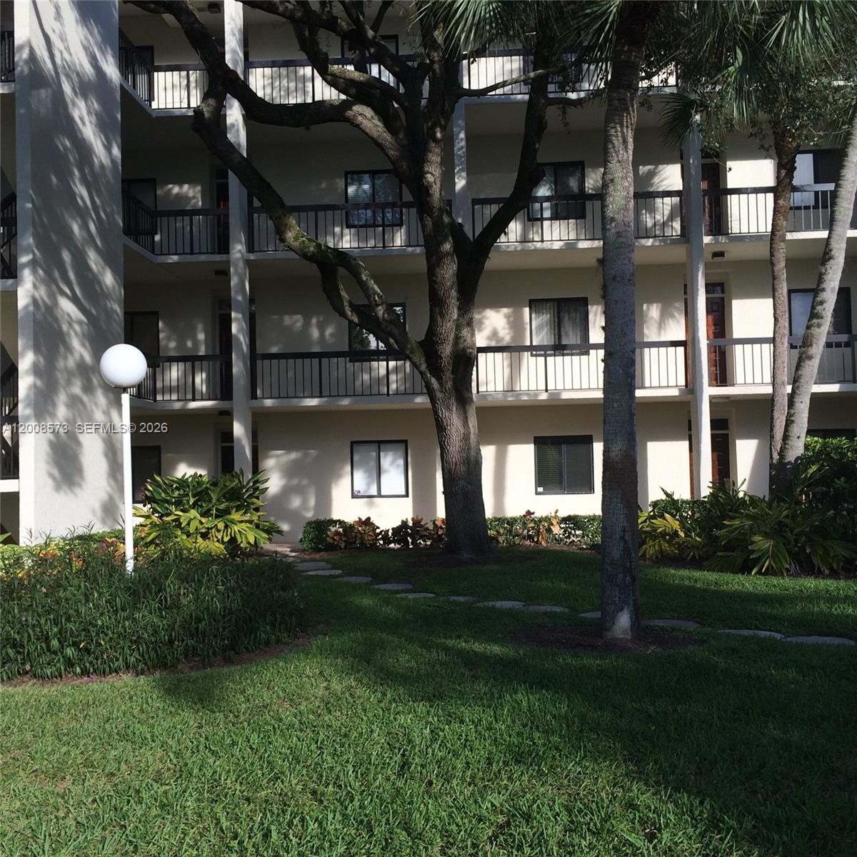 First-floor condo located in a gated golf community with a 24H guard gate. All ages welcome; no mandatory membership for the on-site Banyan Cay Golf Club. This corner unit offers a private and relaxing garden view with an ideal split-bedroom floor plan for privacy. Features include 2 bedrooms, 2 bathrooms, and the convenience of in-unit laundry. Bright and generous entertaining area with a wrap-around balcony. The community offers a pool and clubhouse. Private parking and storage included. Excellent location, steps from the outlets, Downtown, and PBI Airport, and just minutes to the beaches, restaurants, and more. Property will sell fully furnished, Property is rented, please allow 24h for showings.